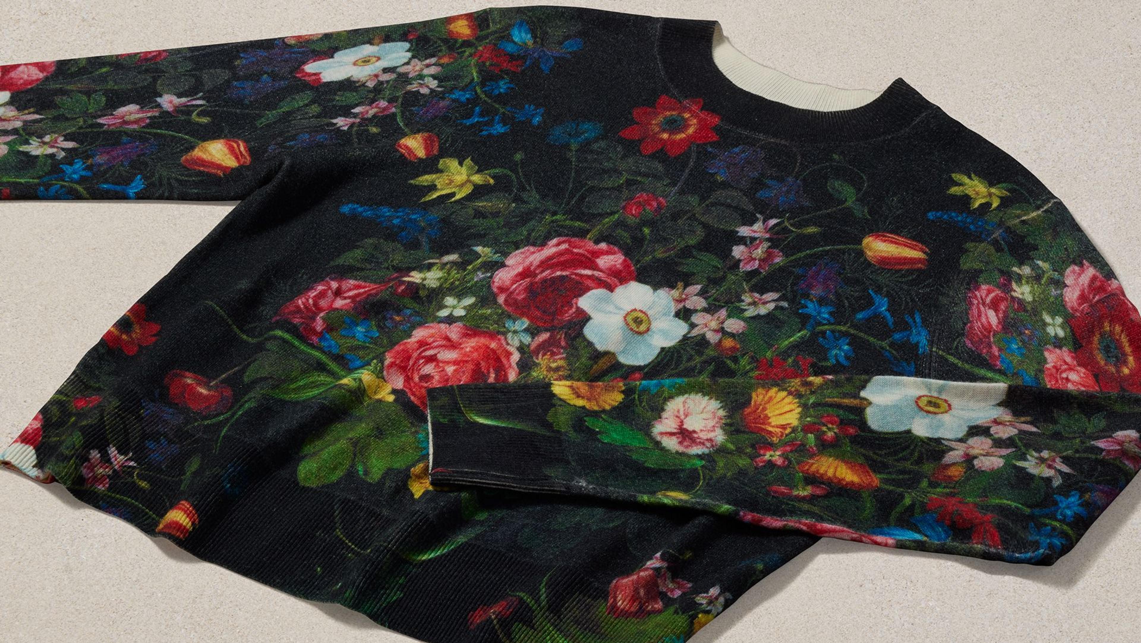 A black sweater with flowers on it.