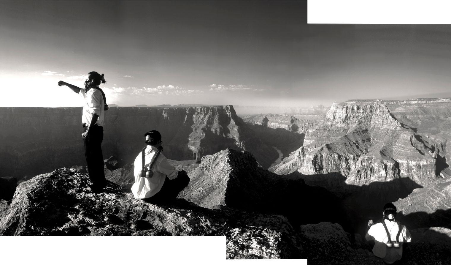 Two men wearing respirator masks looking at the landscape