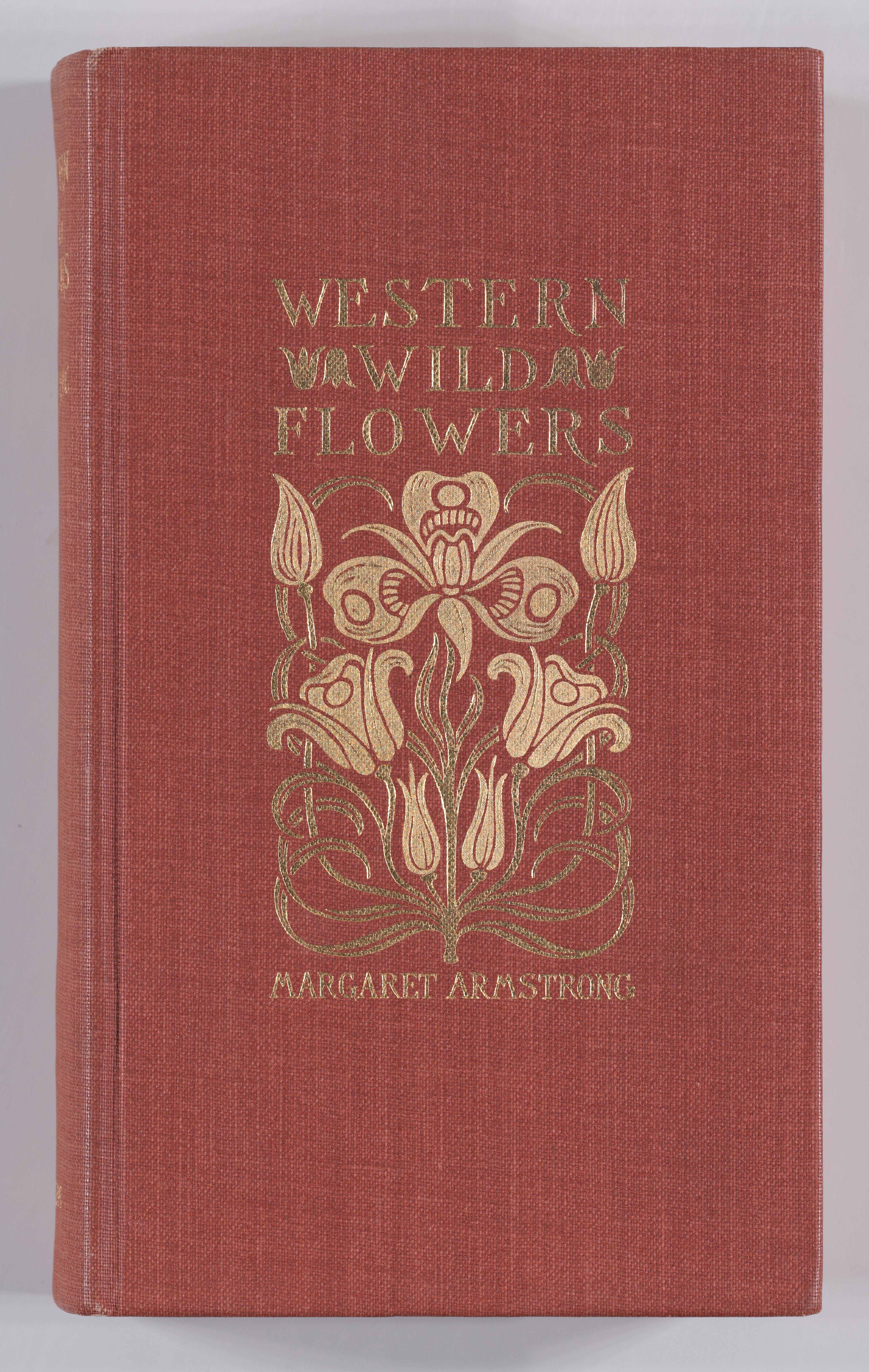 Red cloth book titled “Western Wild Flowers” with gold floral design and lettering on the cover.