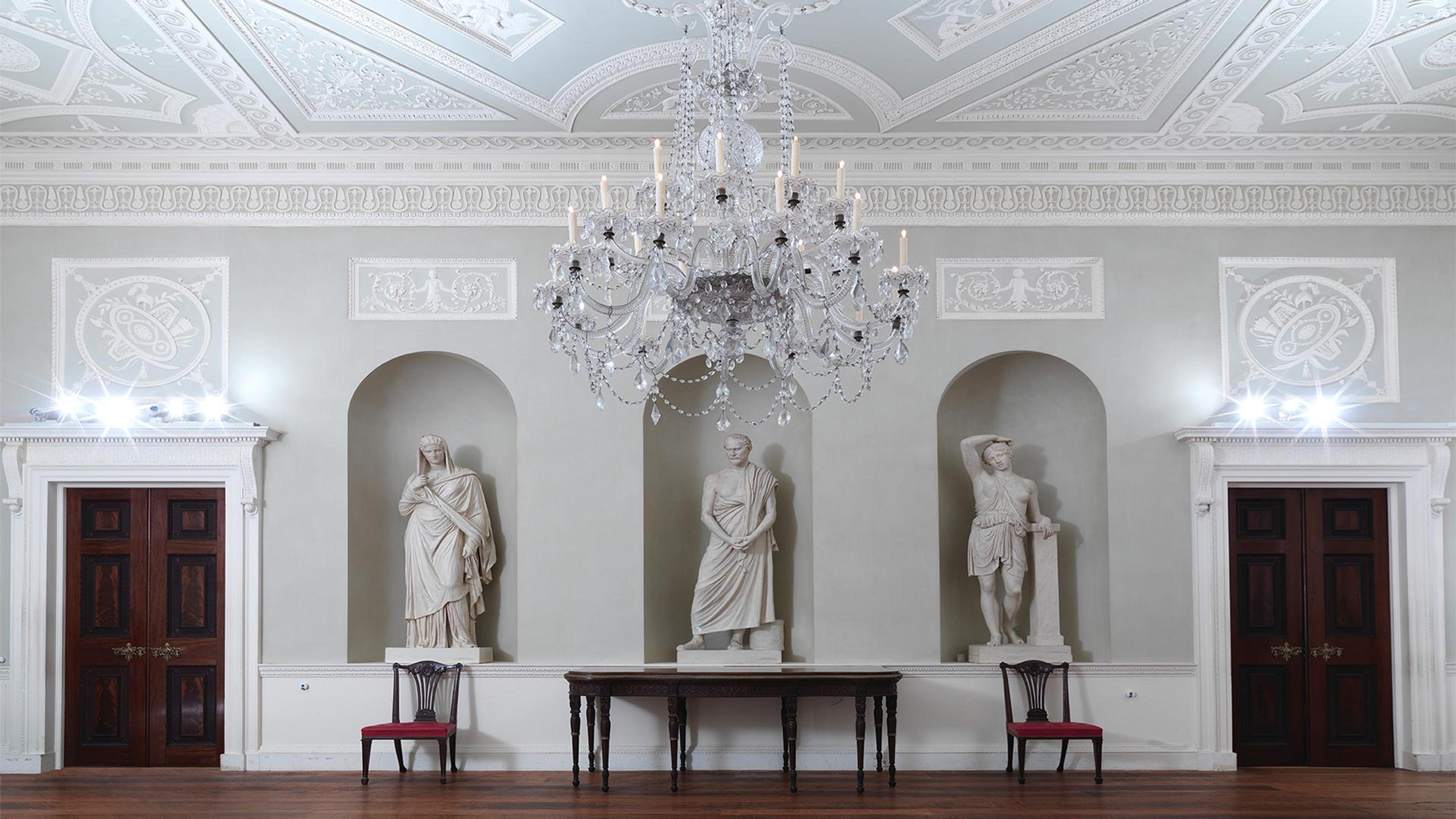 A large, ornate dining room with three sculptural niches