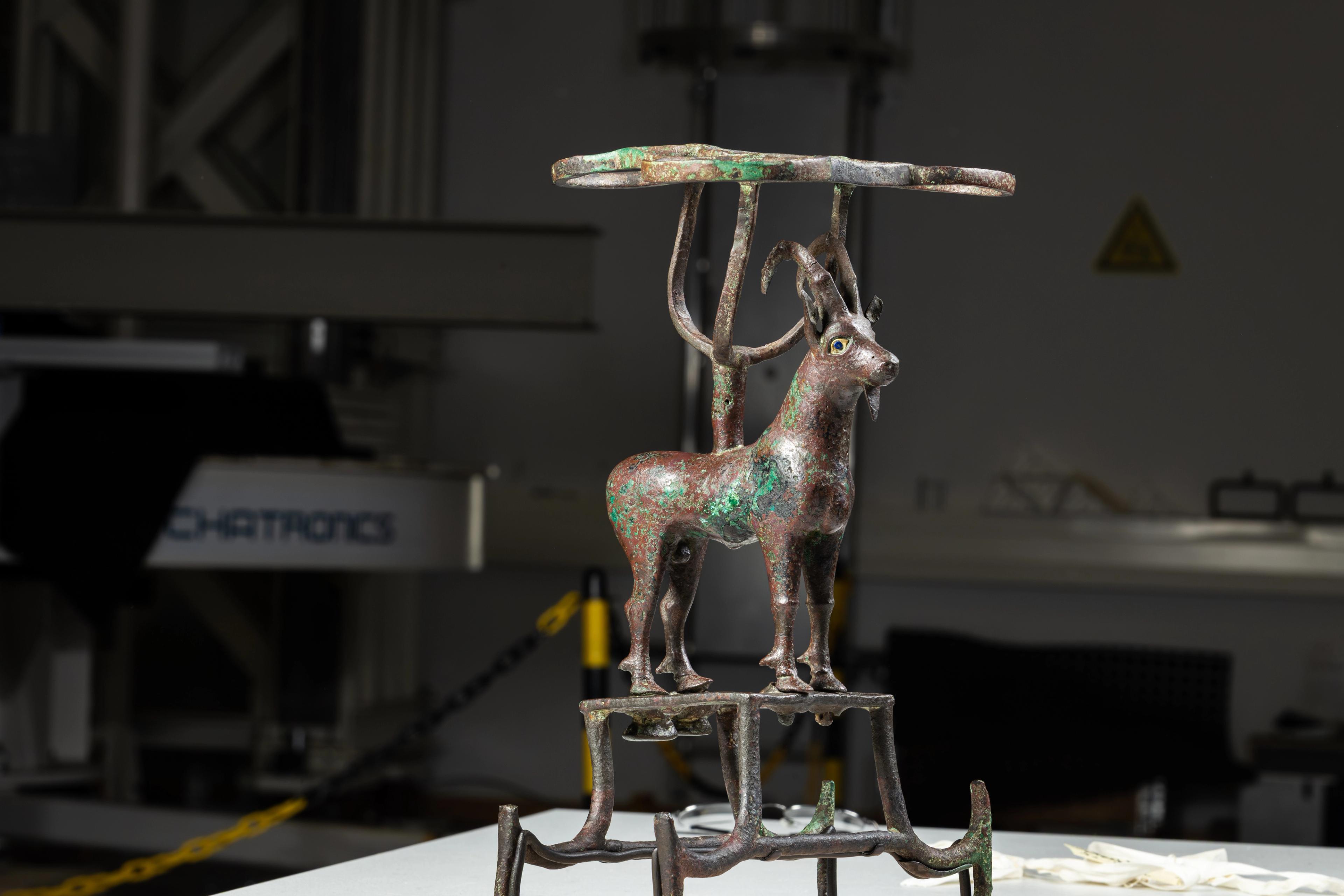 a bronze sculpture of an ibex