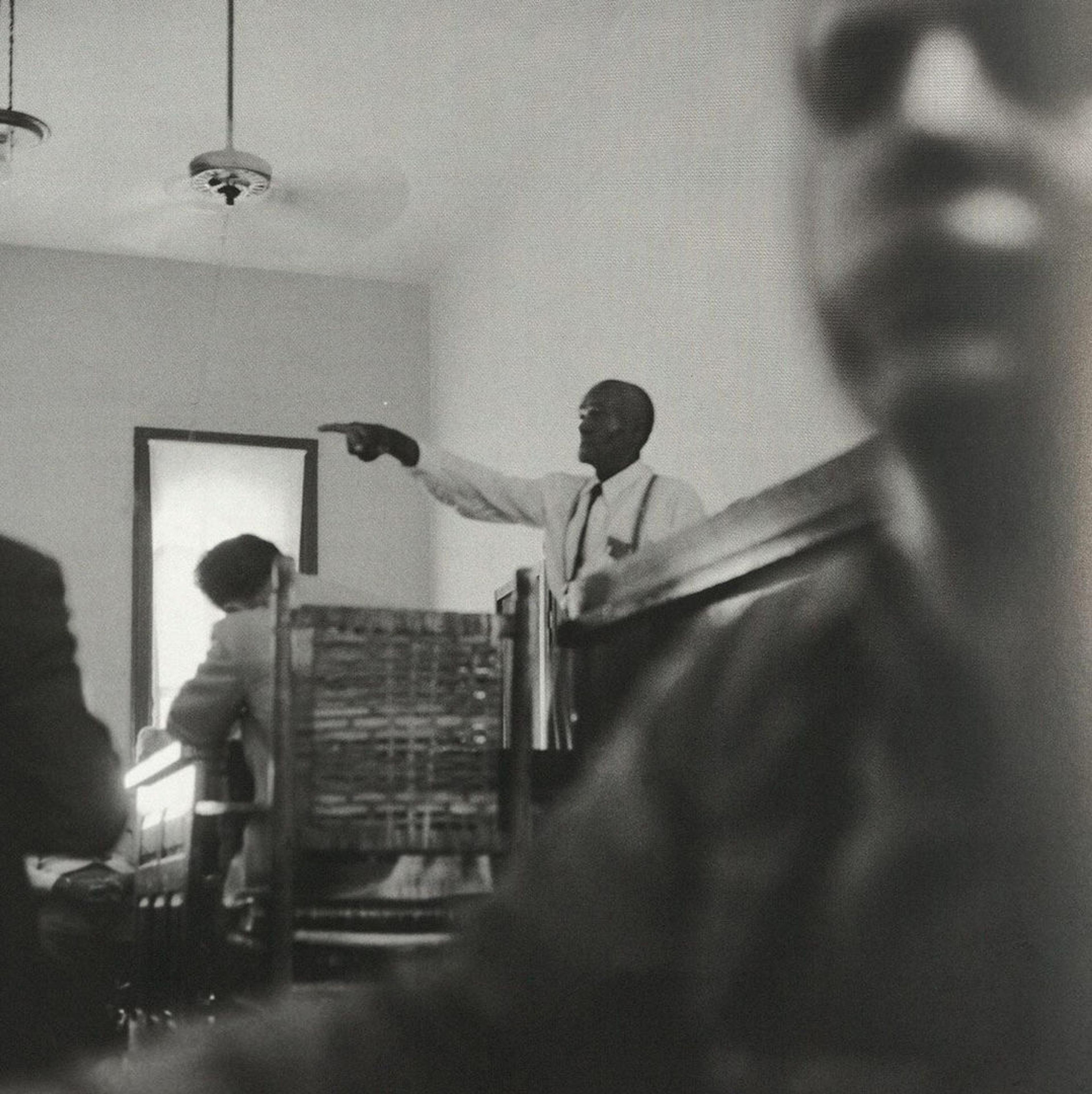 Candid photograph from a courtroom featuring a man pointing