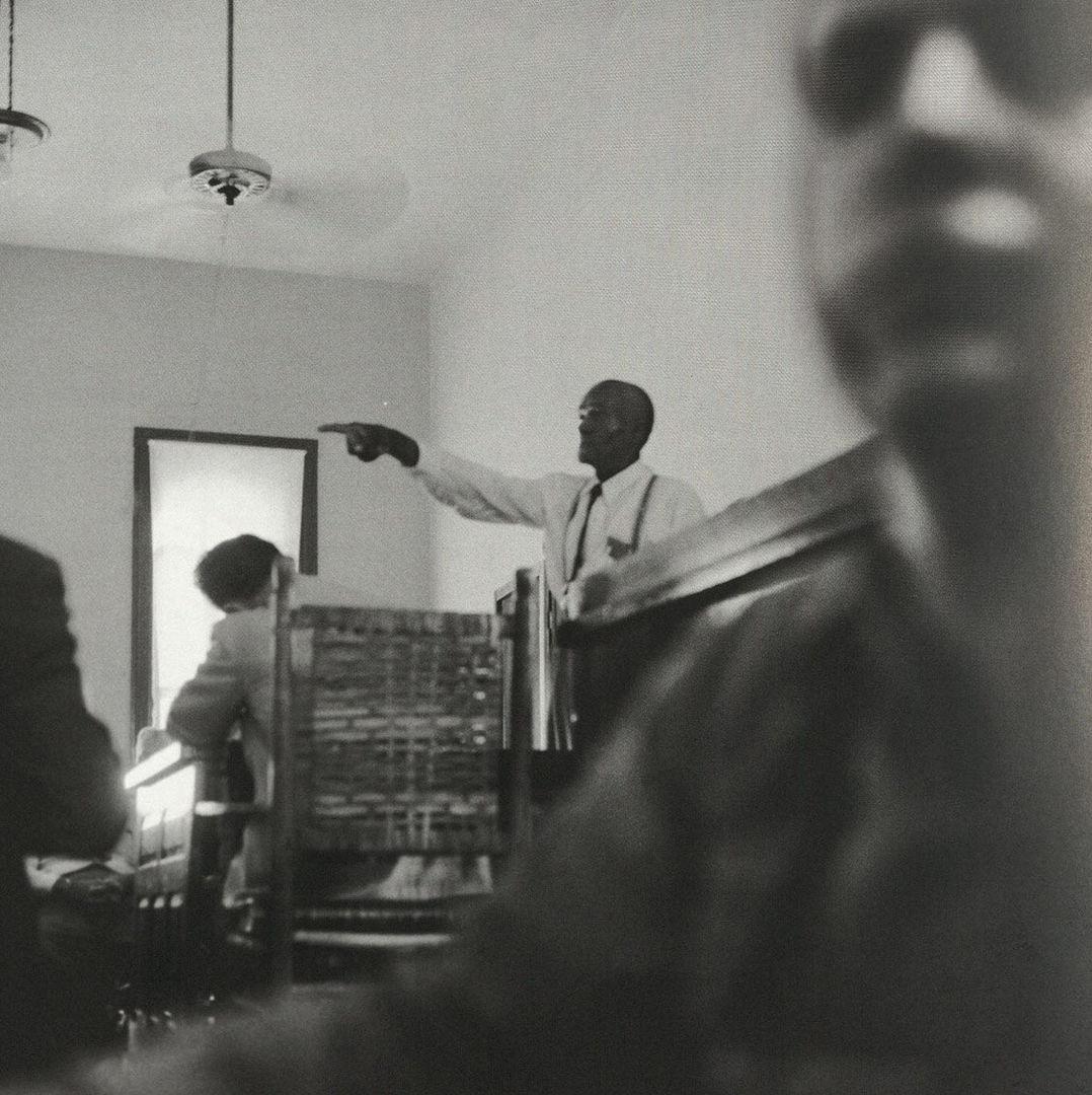 Candid photograph from a courtroom featuring a man pointing