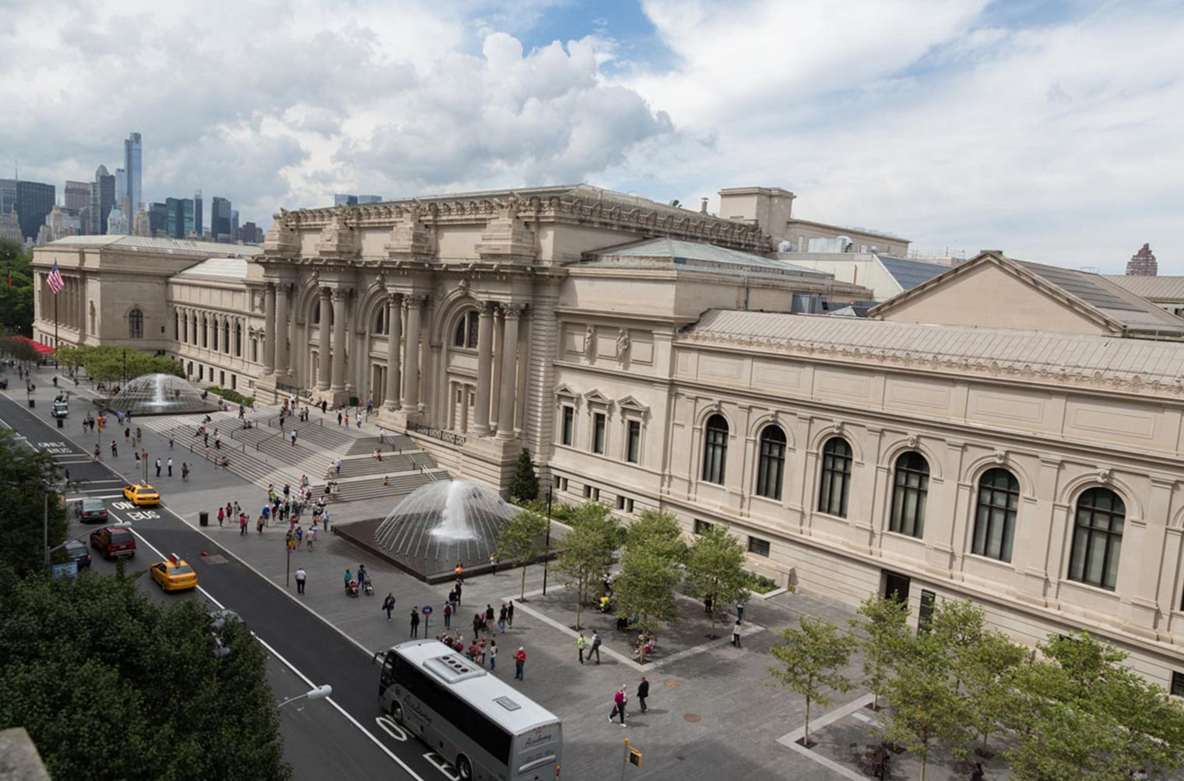 Birds eye view photograph of a sprawling marble building and a large street