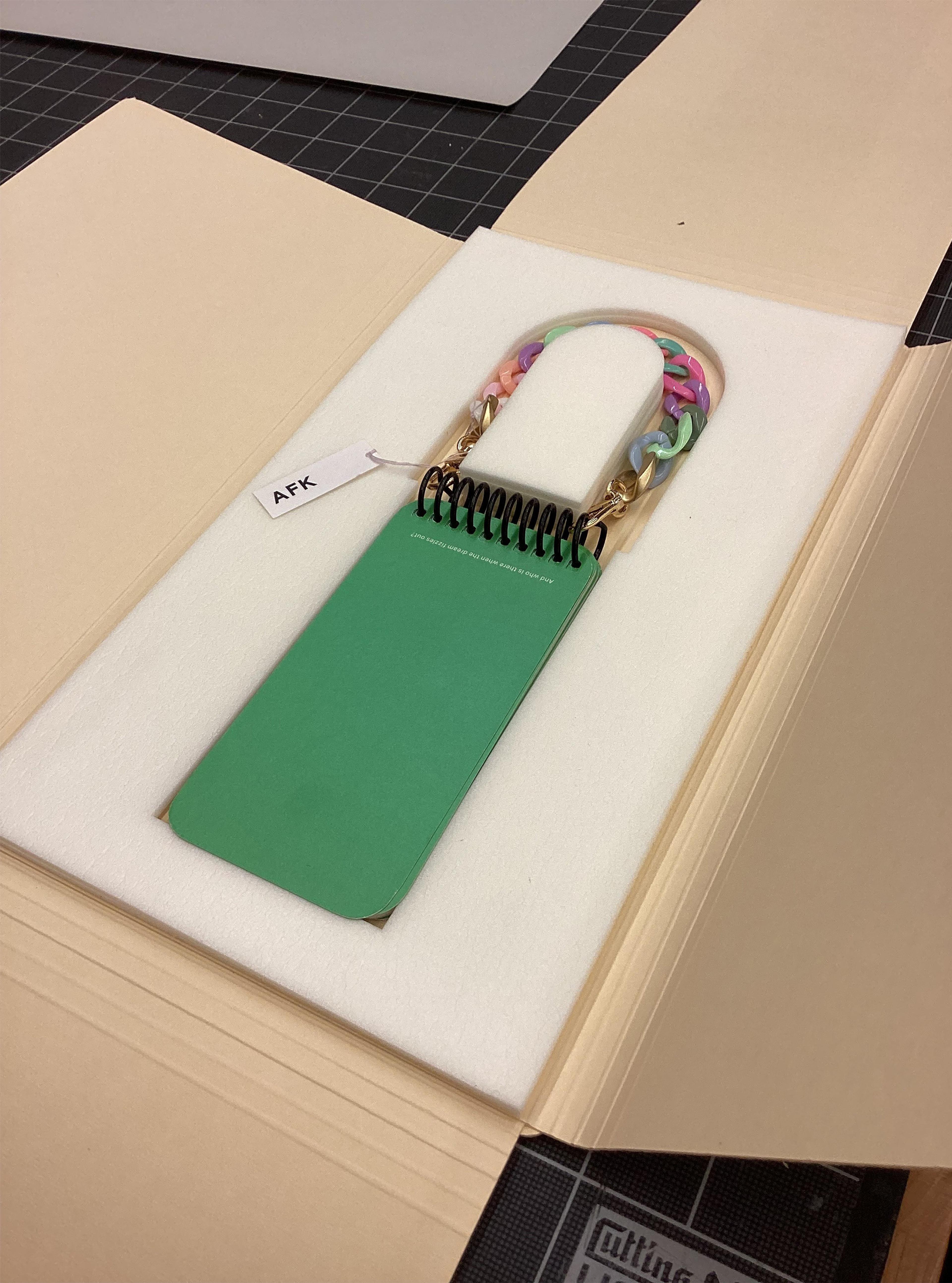 Two different boxes holding uncommonly shaped books