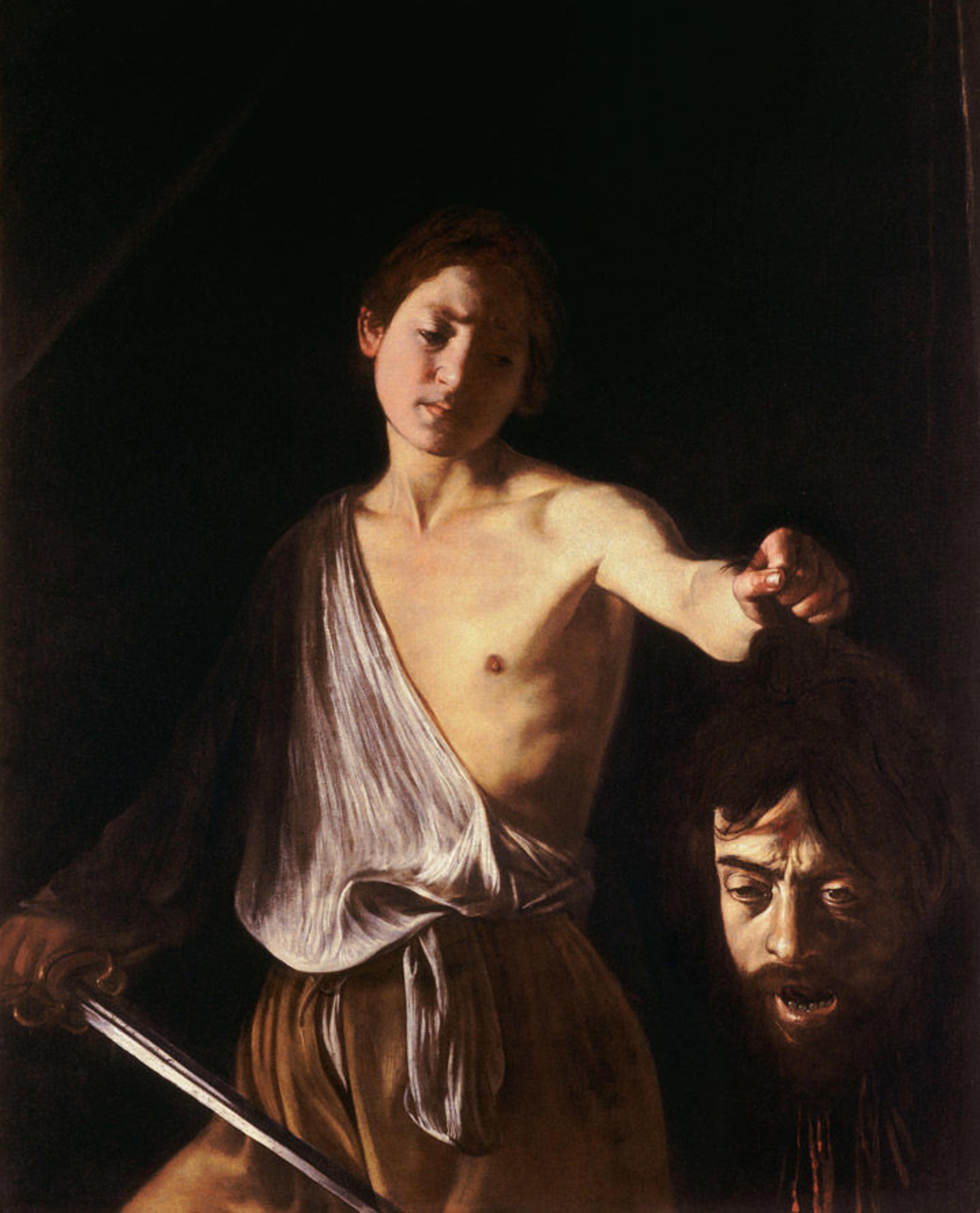 A dark Italian Baroque painting showing a young David holding a sword and the severed head of Goliath