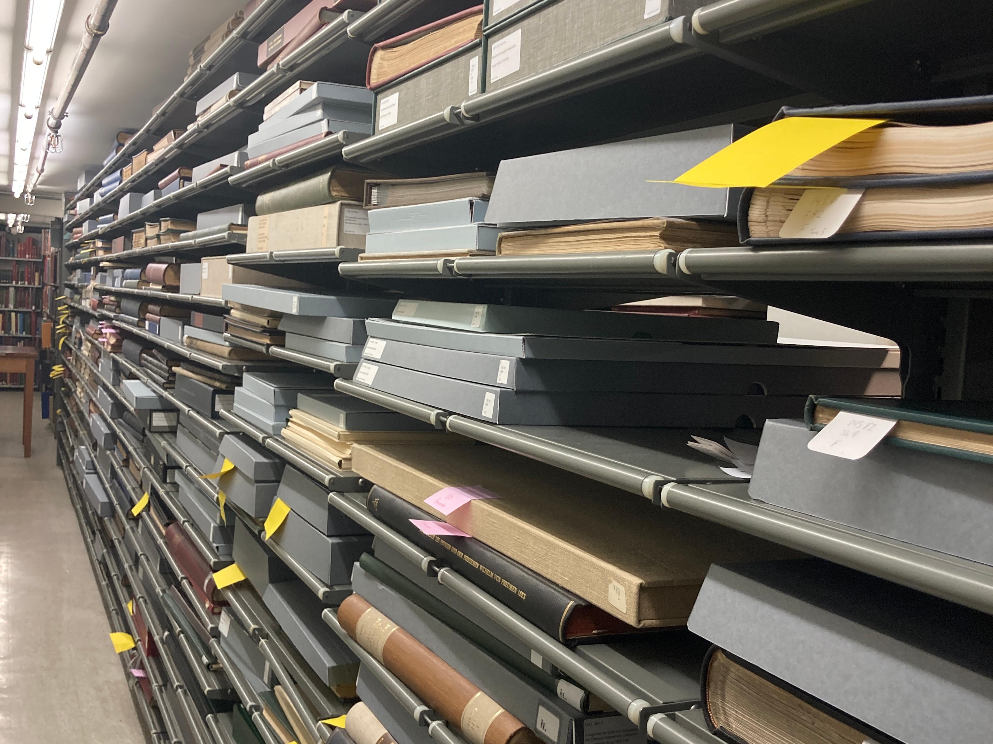 Yellow slips of paper sticking out of folios on shelves