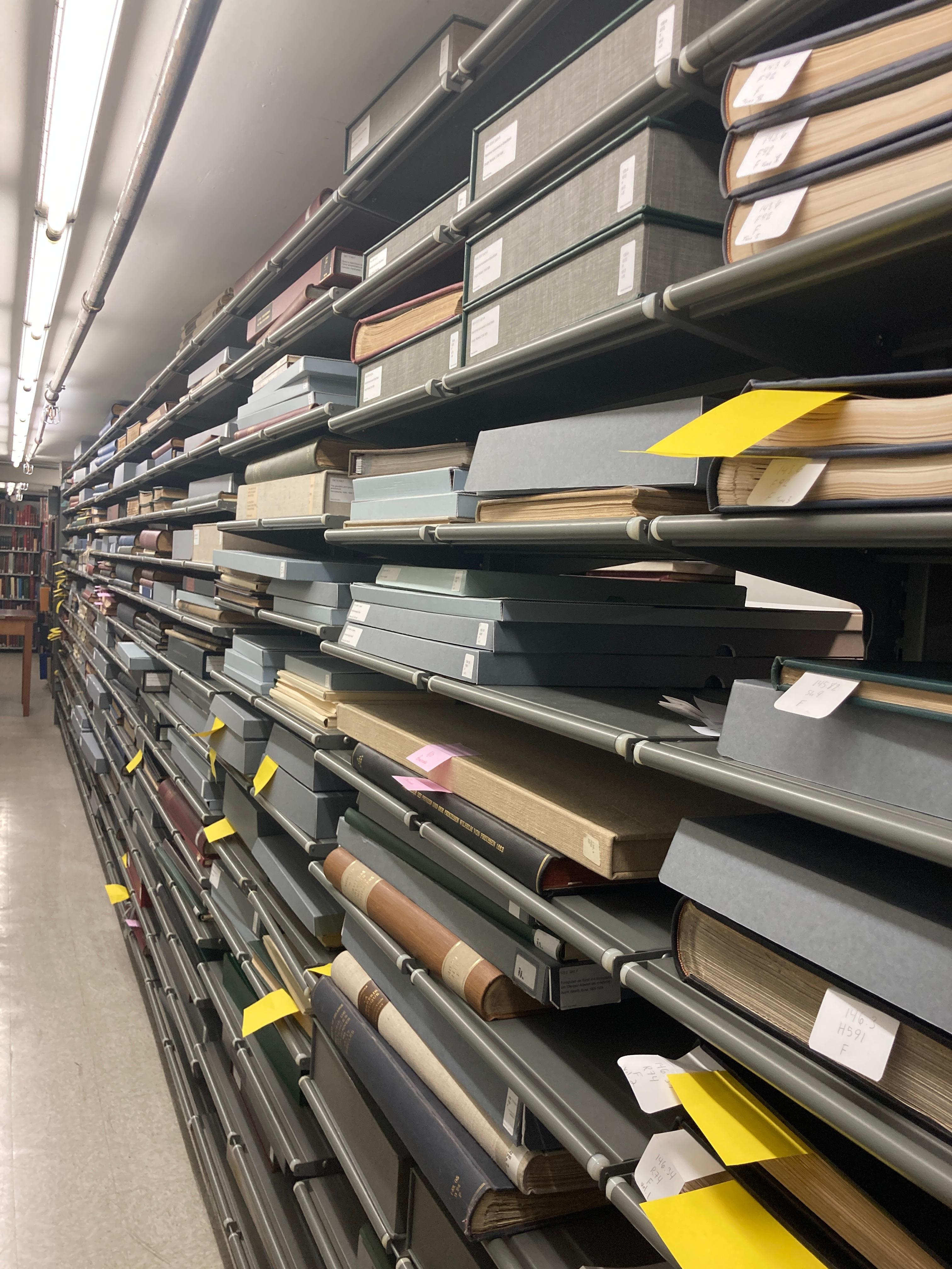Yellow slips of paper sticking out of folios on shelves