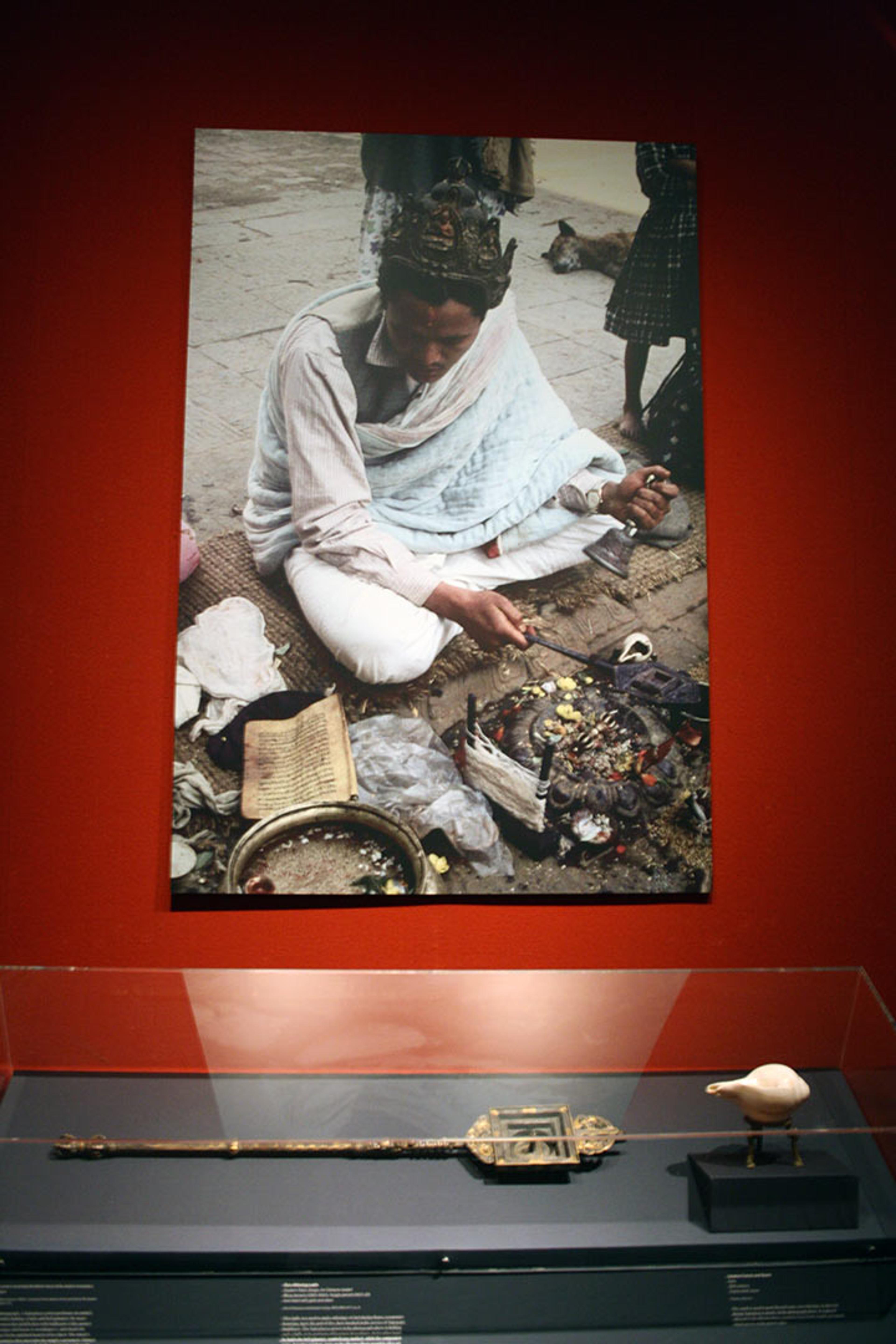 Installation view of gallery wall showing photograph of Buddhist ritual