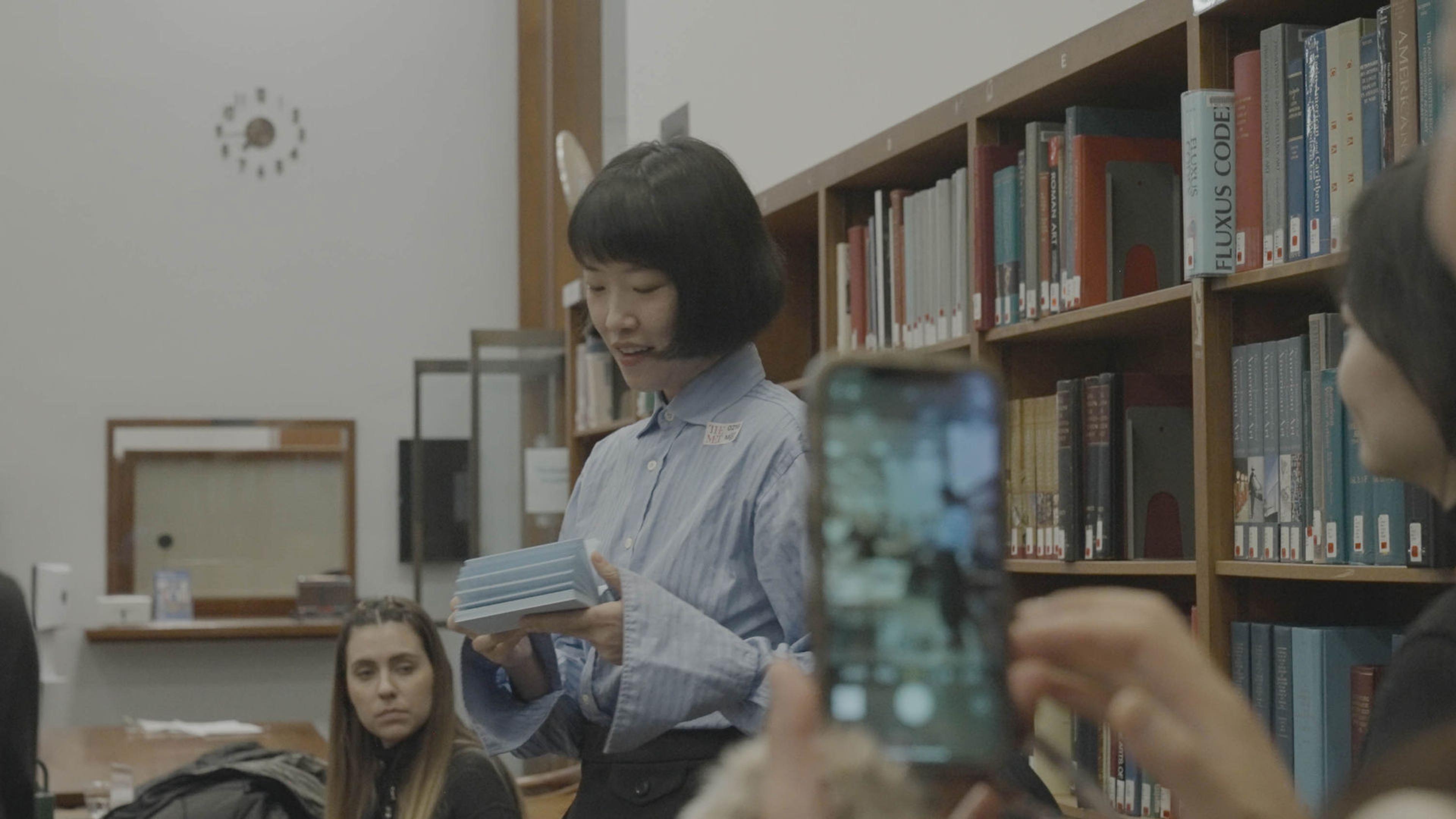 Person filming speaker on their cellphone