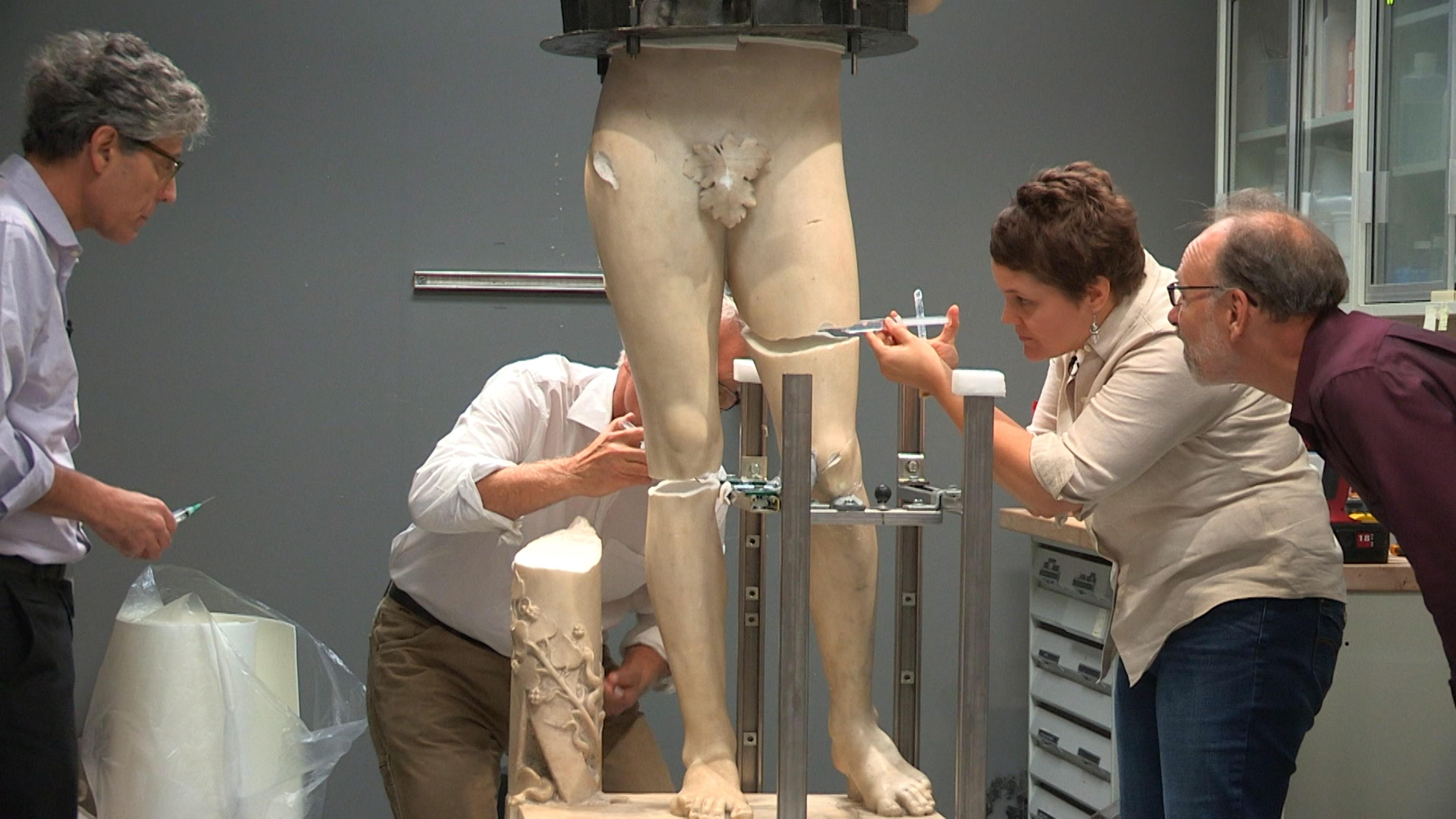 Conservators at work restoring Tullio Lombardo’s sculpture of Adam.