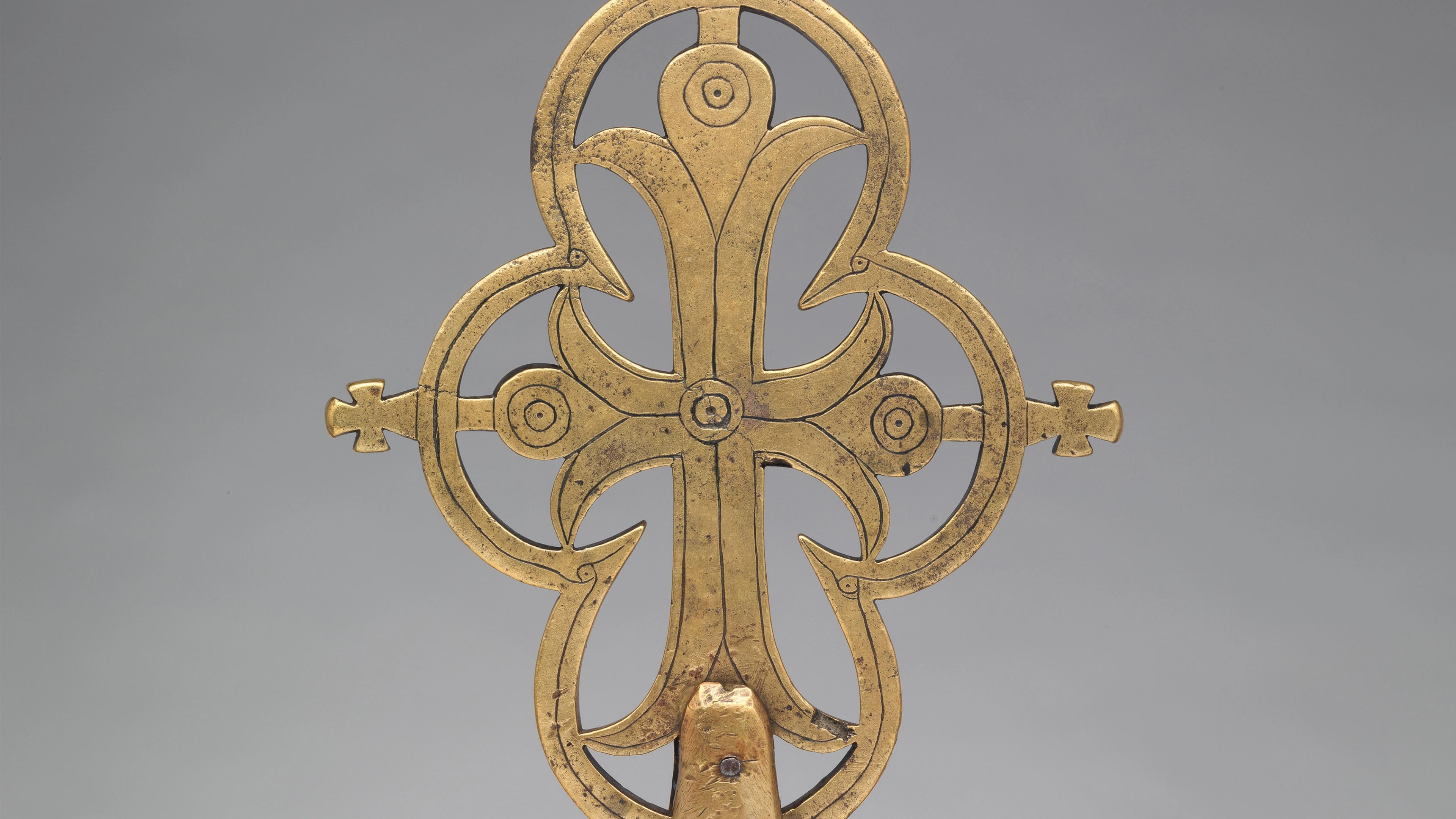 Close up of a bronze liturgical trifoliate cross