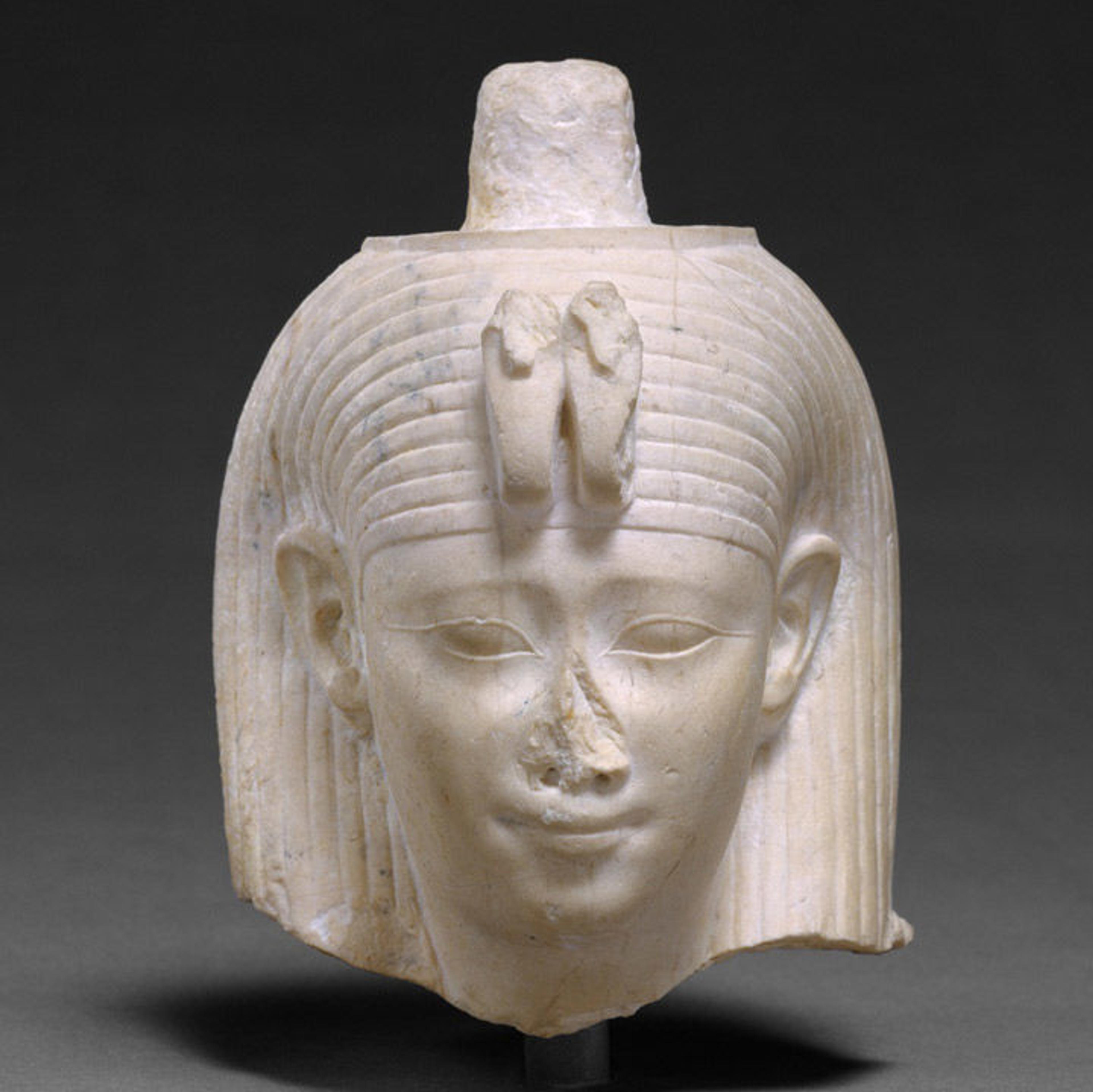 White limestone bust with a serpent-adorned headdress.