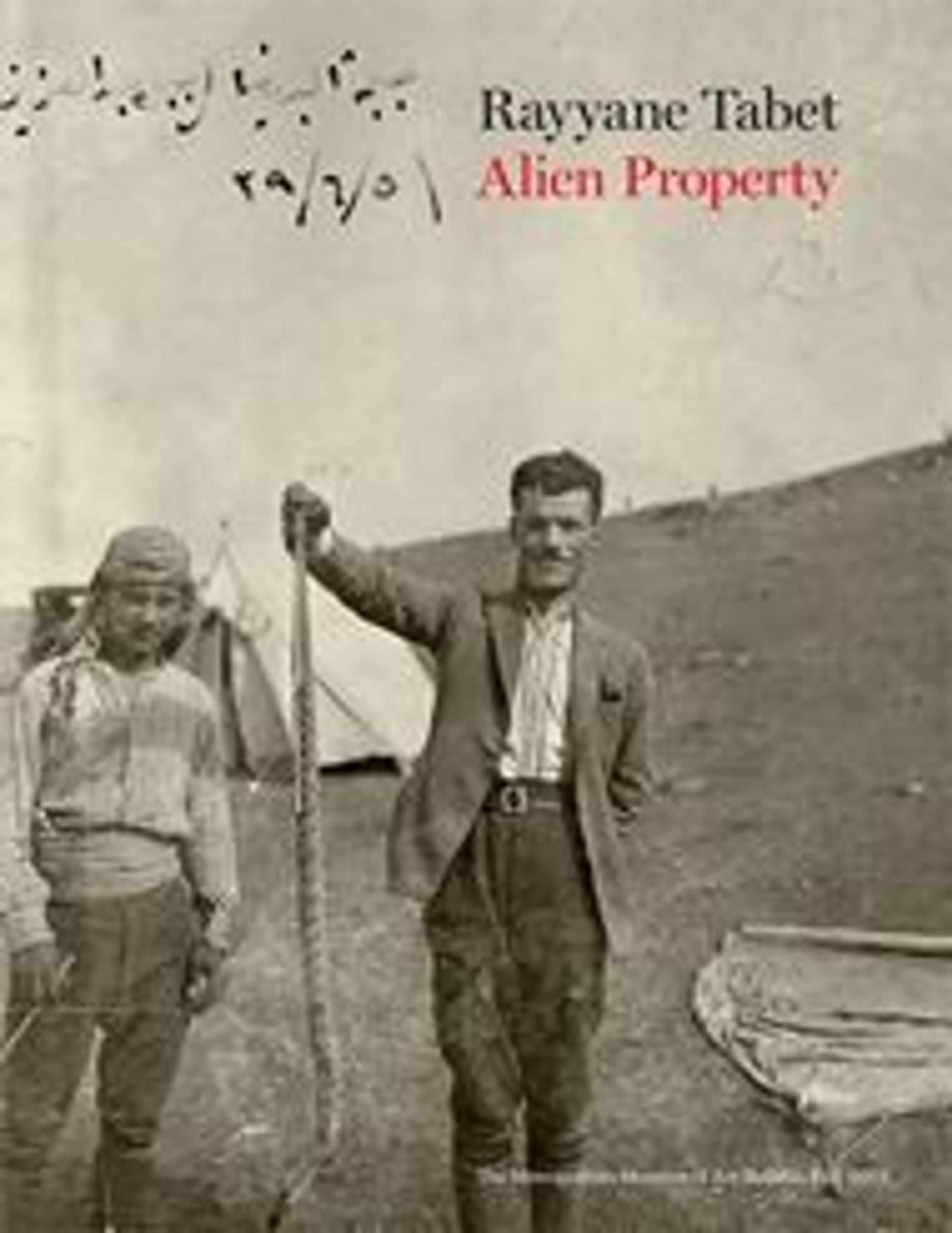 A sepia photograph of two men standing in a desert