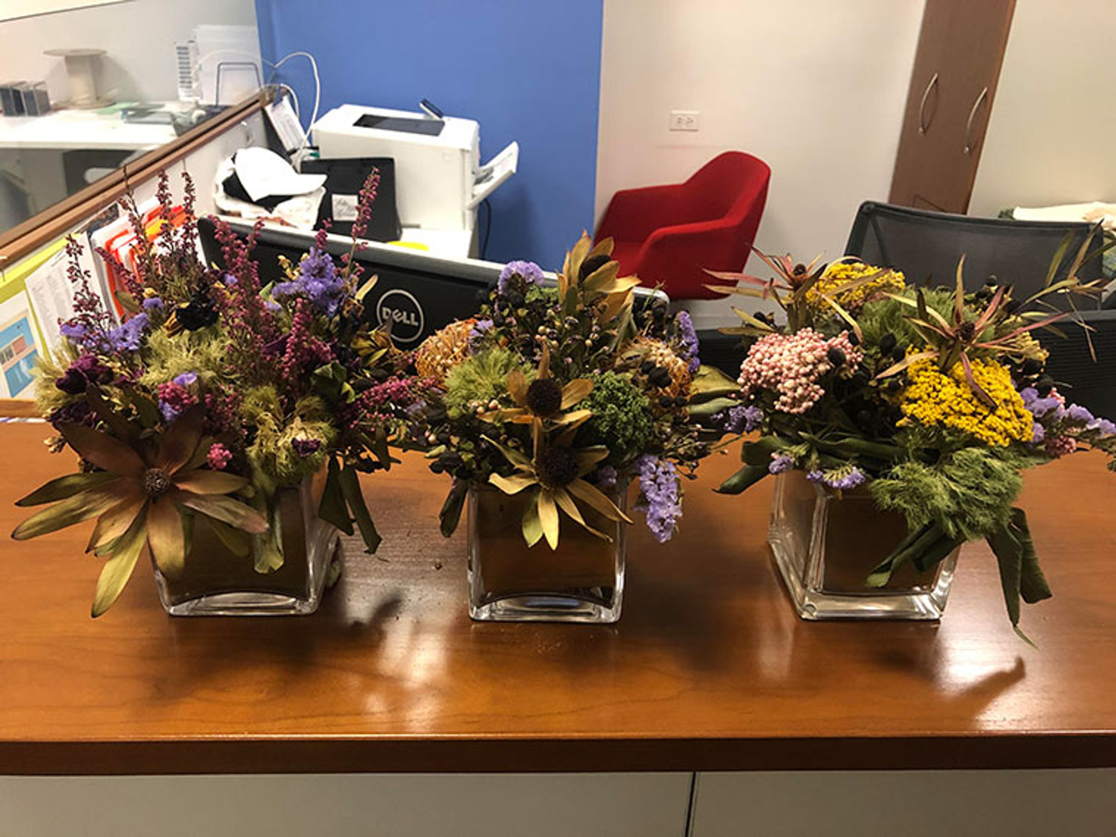 Three vases full of desiccated flowers