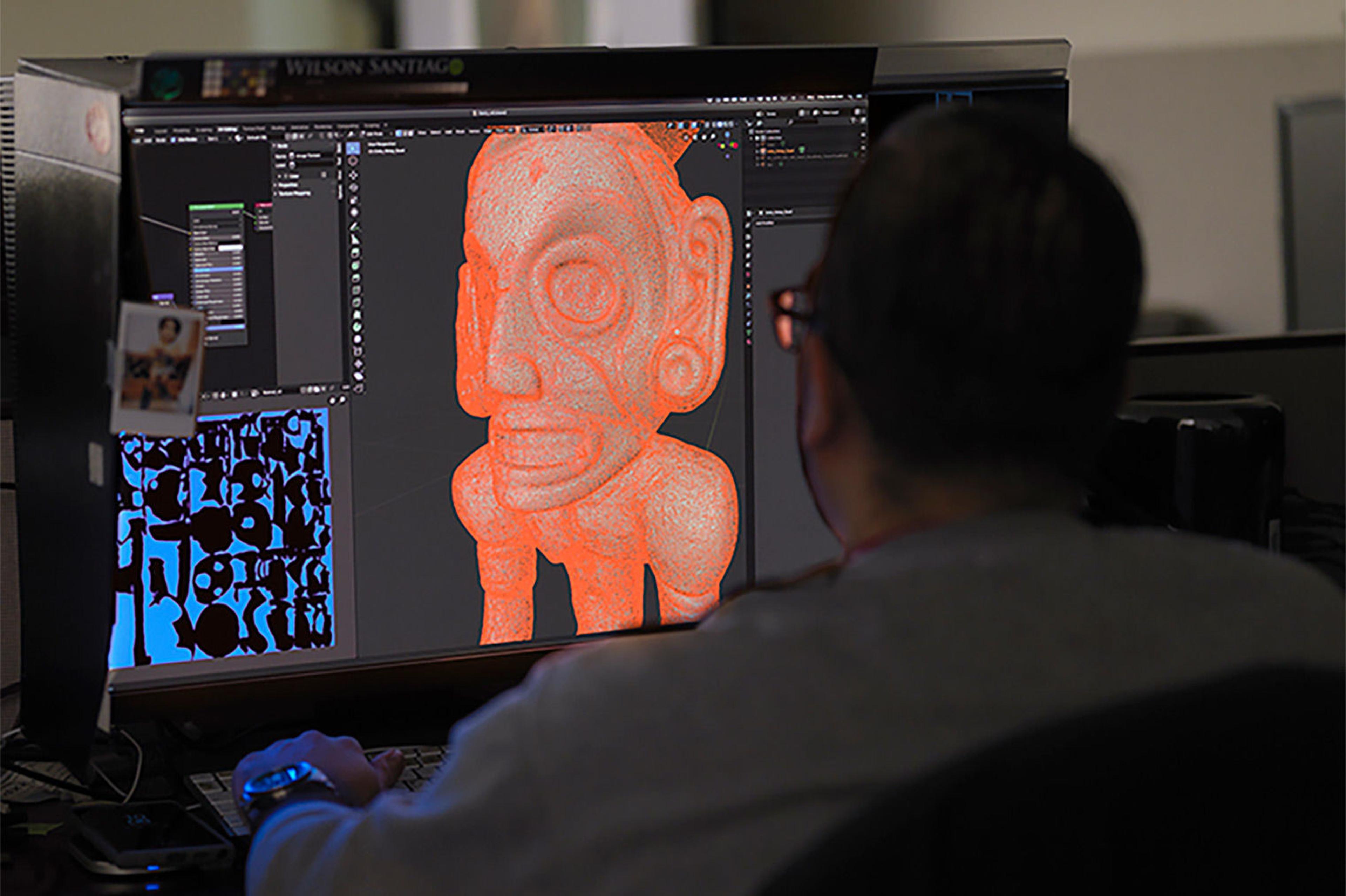 A photo of a man working on a 3D model on a computer