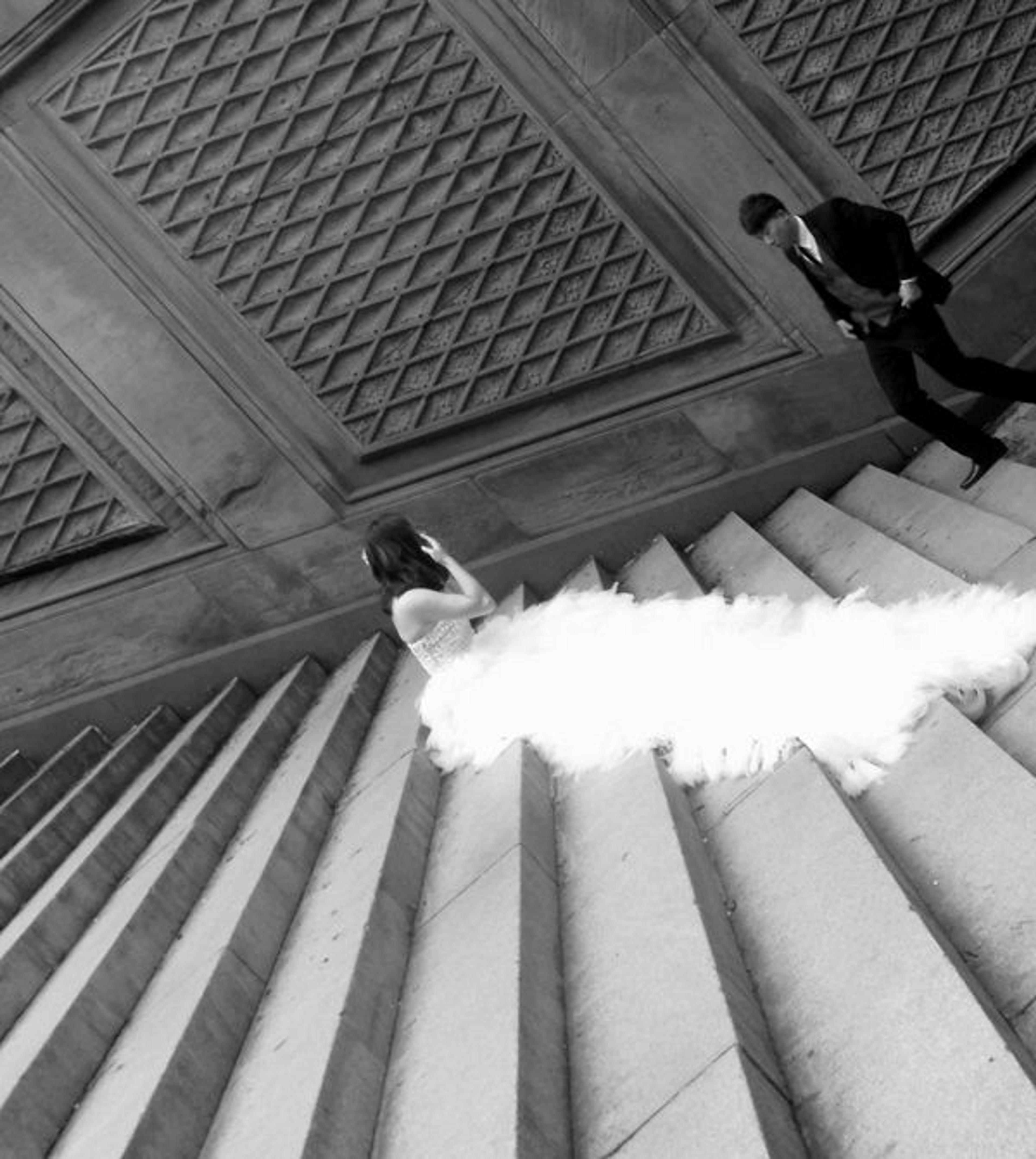 Bride sitting on steps, shot on an angle