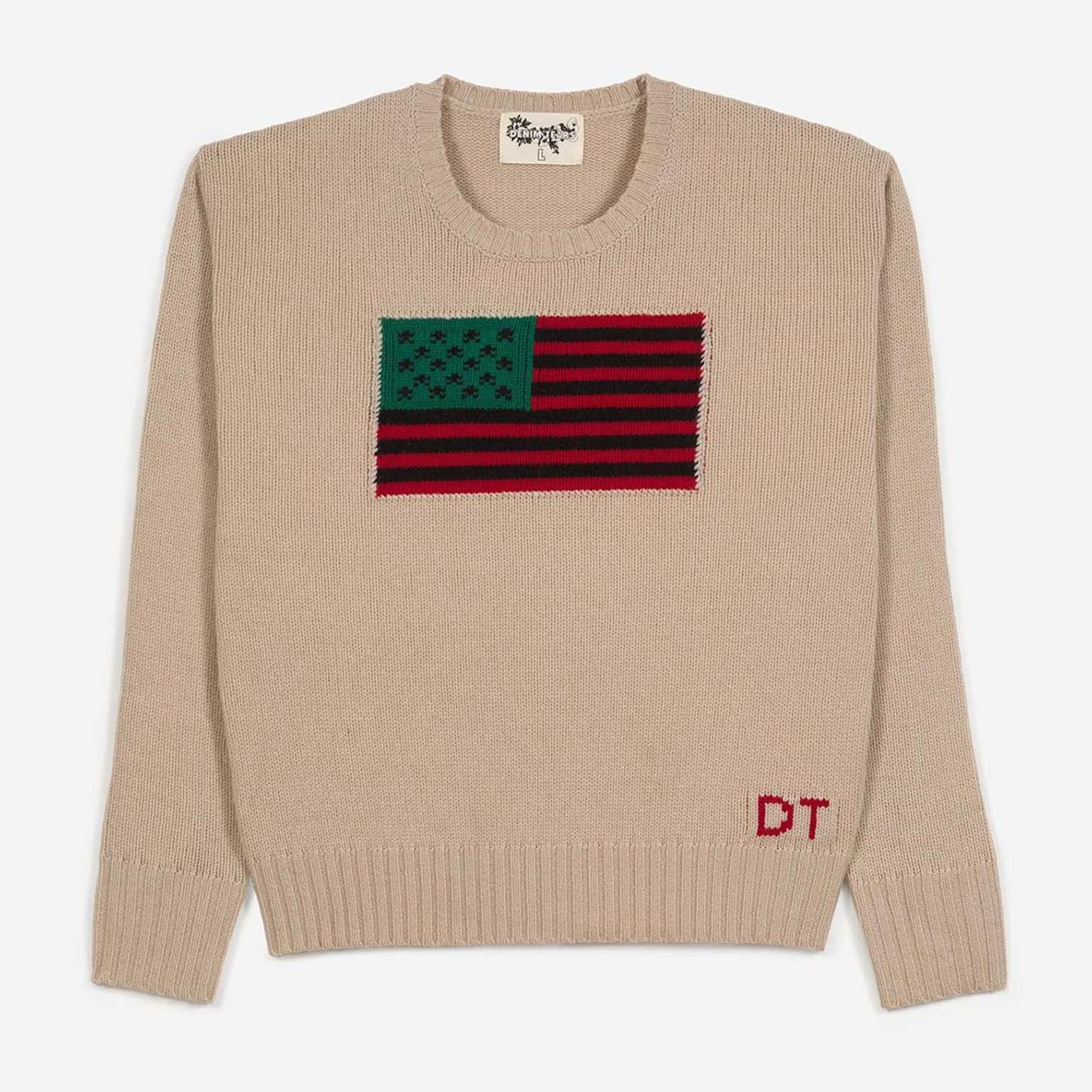“Tyson Beckford” beige crewneck sweater with the Pan African flag