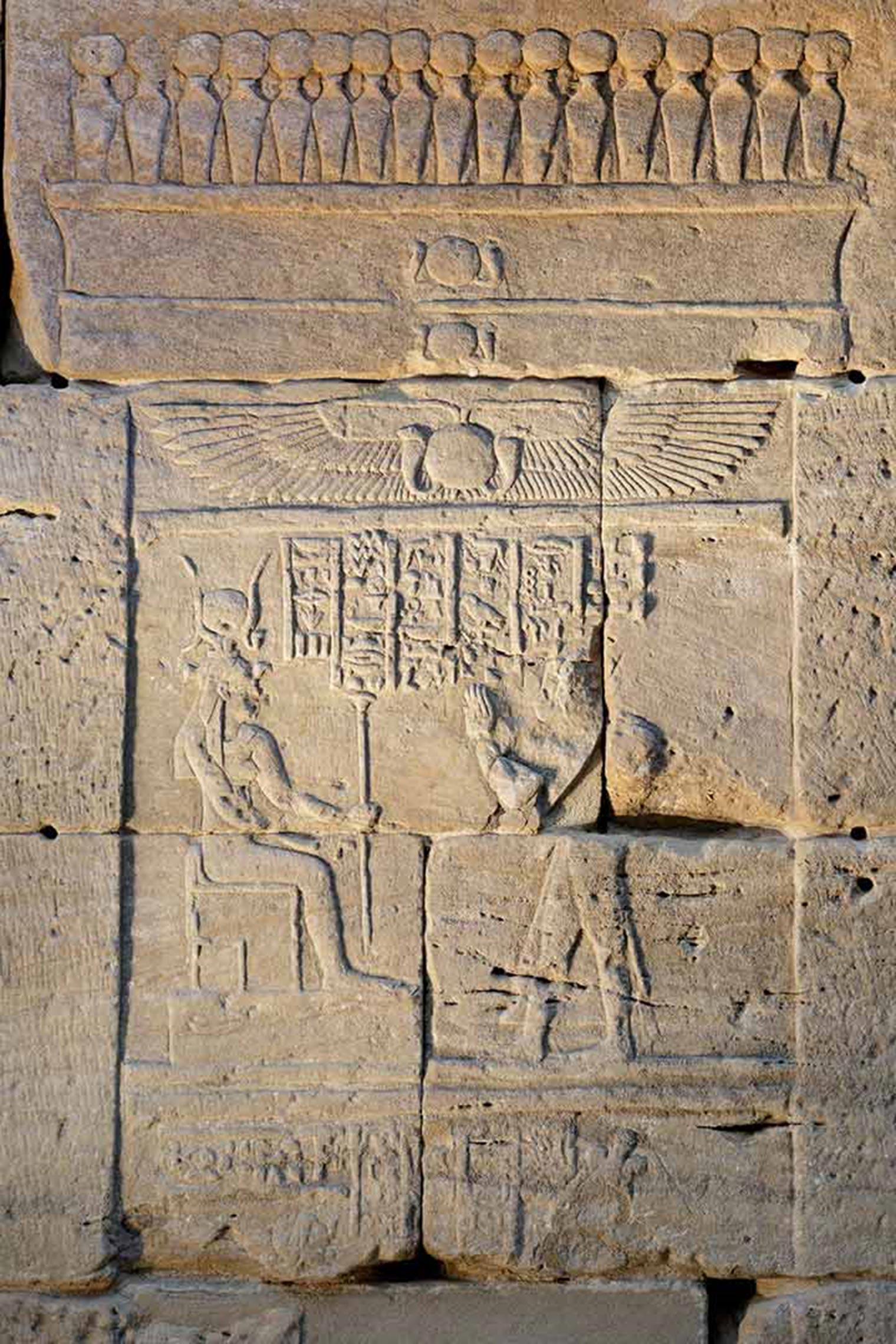 Detail depicting a shrine with a frieze of cobras at the top. In the scene below is a depiction of Pihor (right) adoring Isis (left).