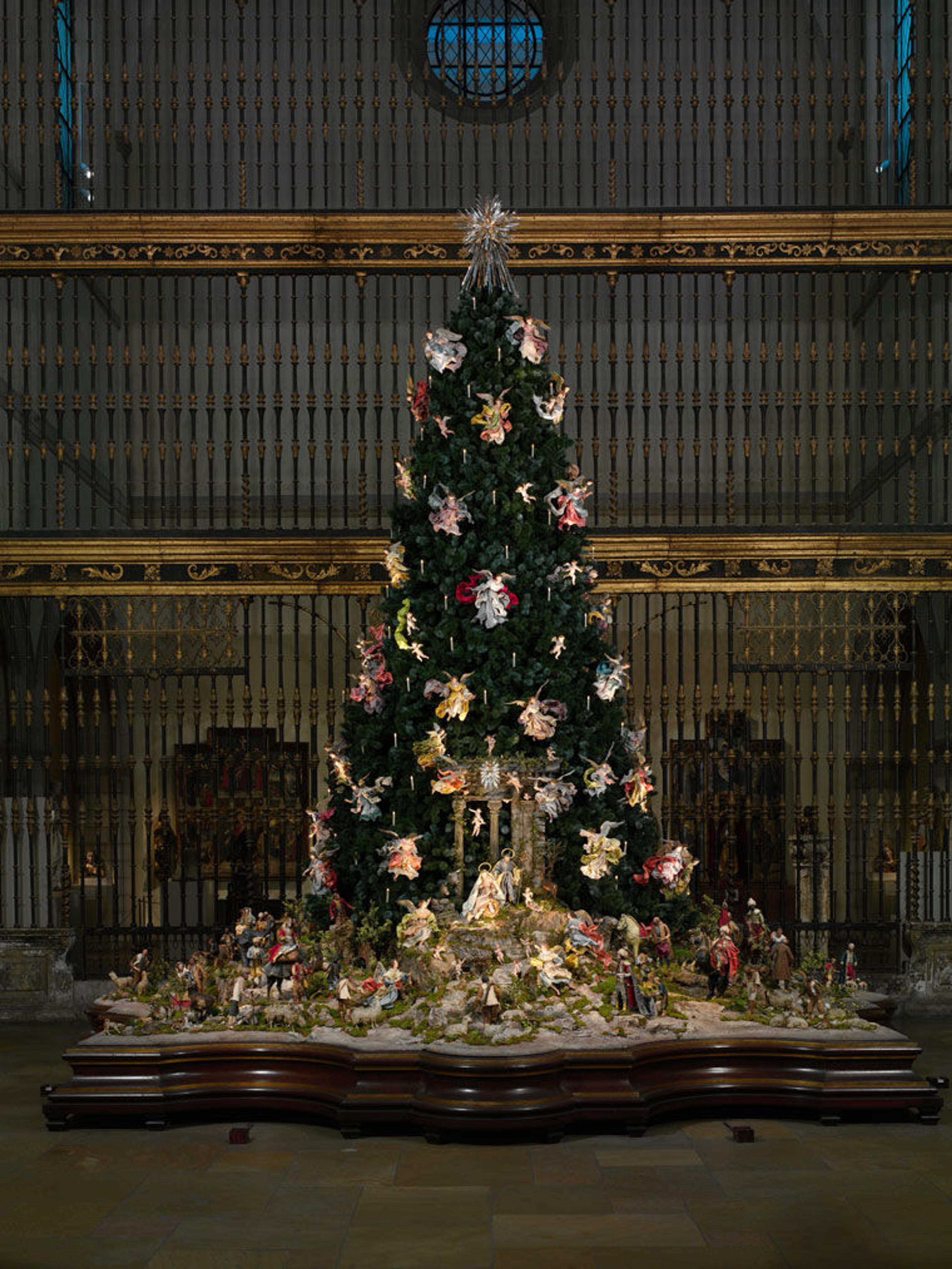 View of The Met's Christmas tree and Neapolitan creche installed in a medieval sculpture gallery