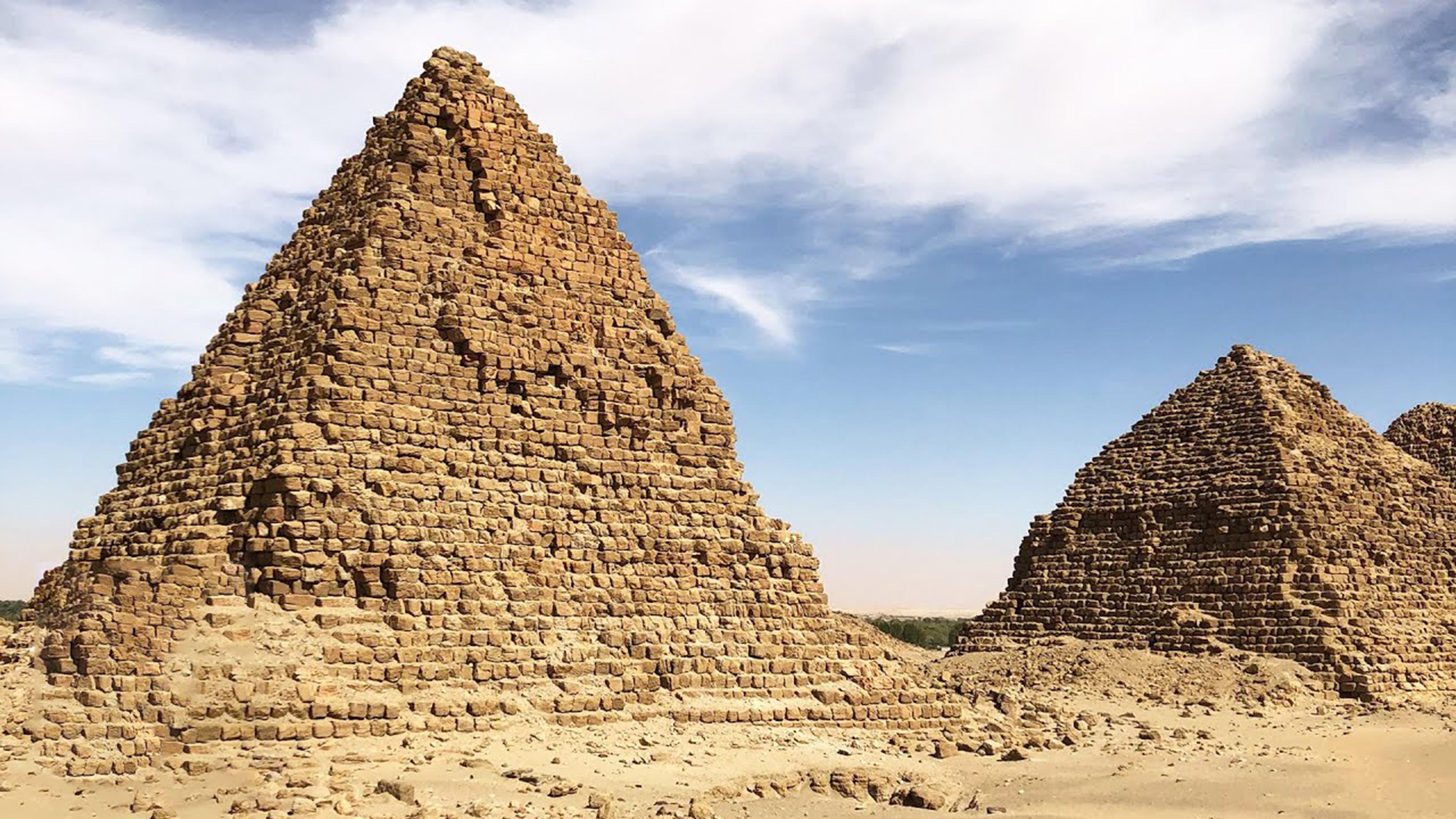 Two pyramids constructed of sandy-colored rectangular bricks