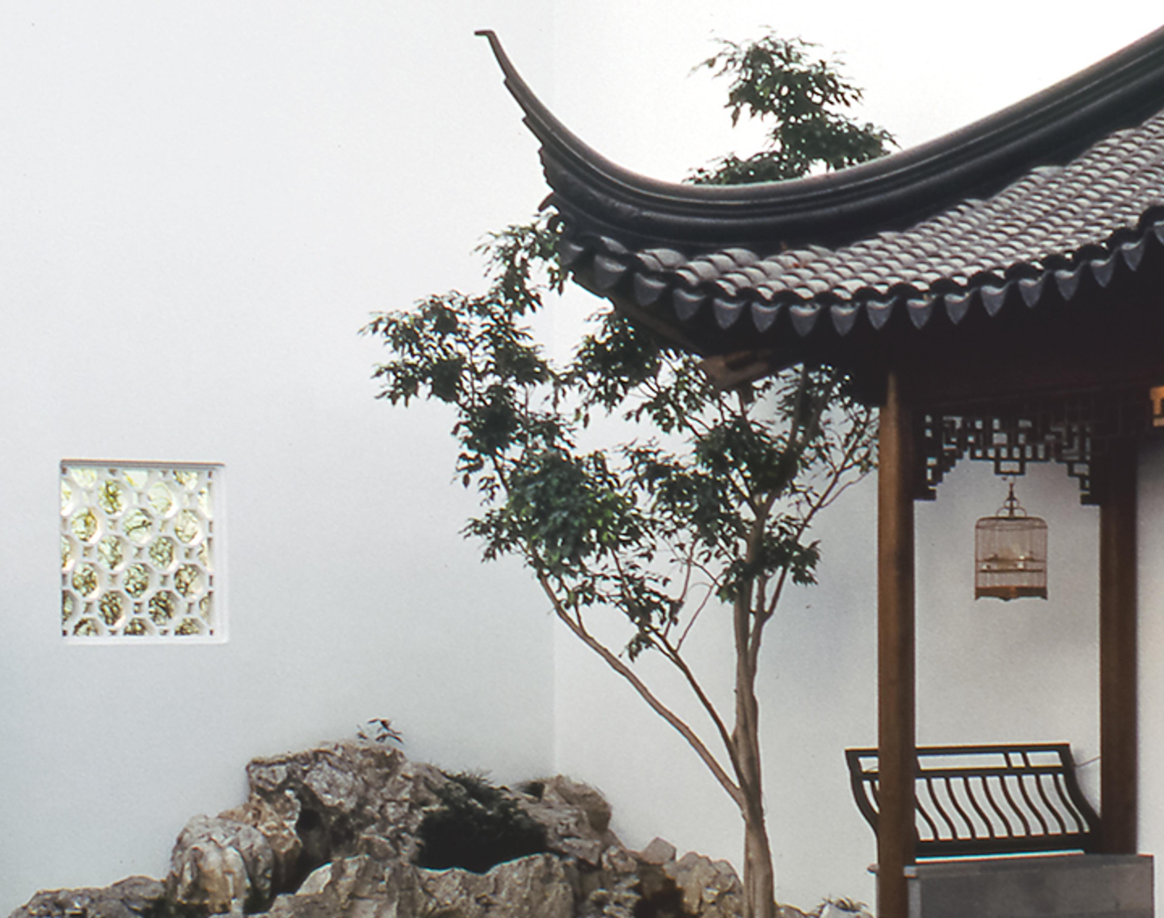 Detail of the pavilion of The Astor Chinese Garden Court. On the gray roof you can see triangular tiles and latticework.