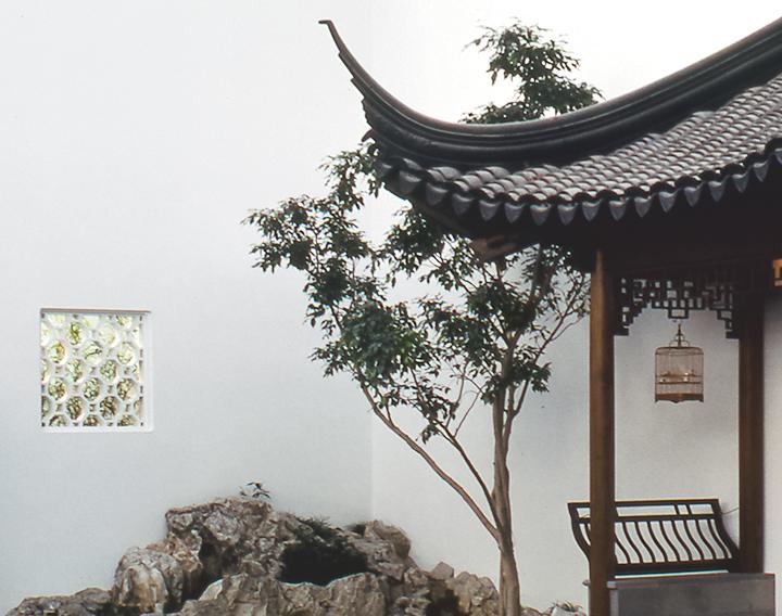 Detail of the pavilion of The Astor Chinese Garden Court. On the gray roof you can see triangular tiles and latticework.