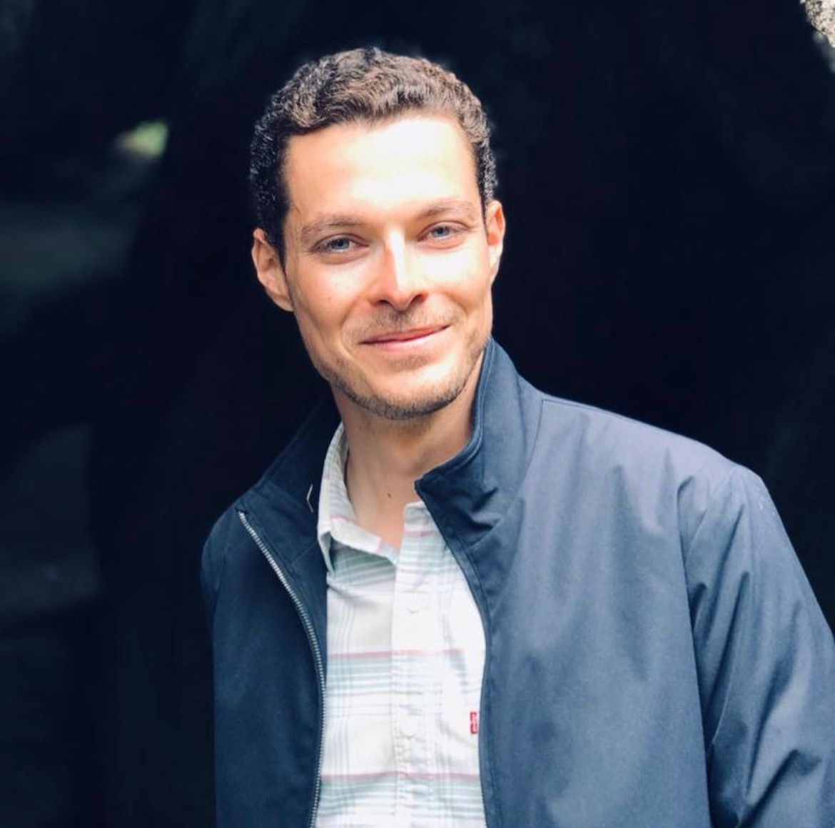 Photo of Vincent Morel head-on. He is wearing a blue jacket and white collared shirt.