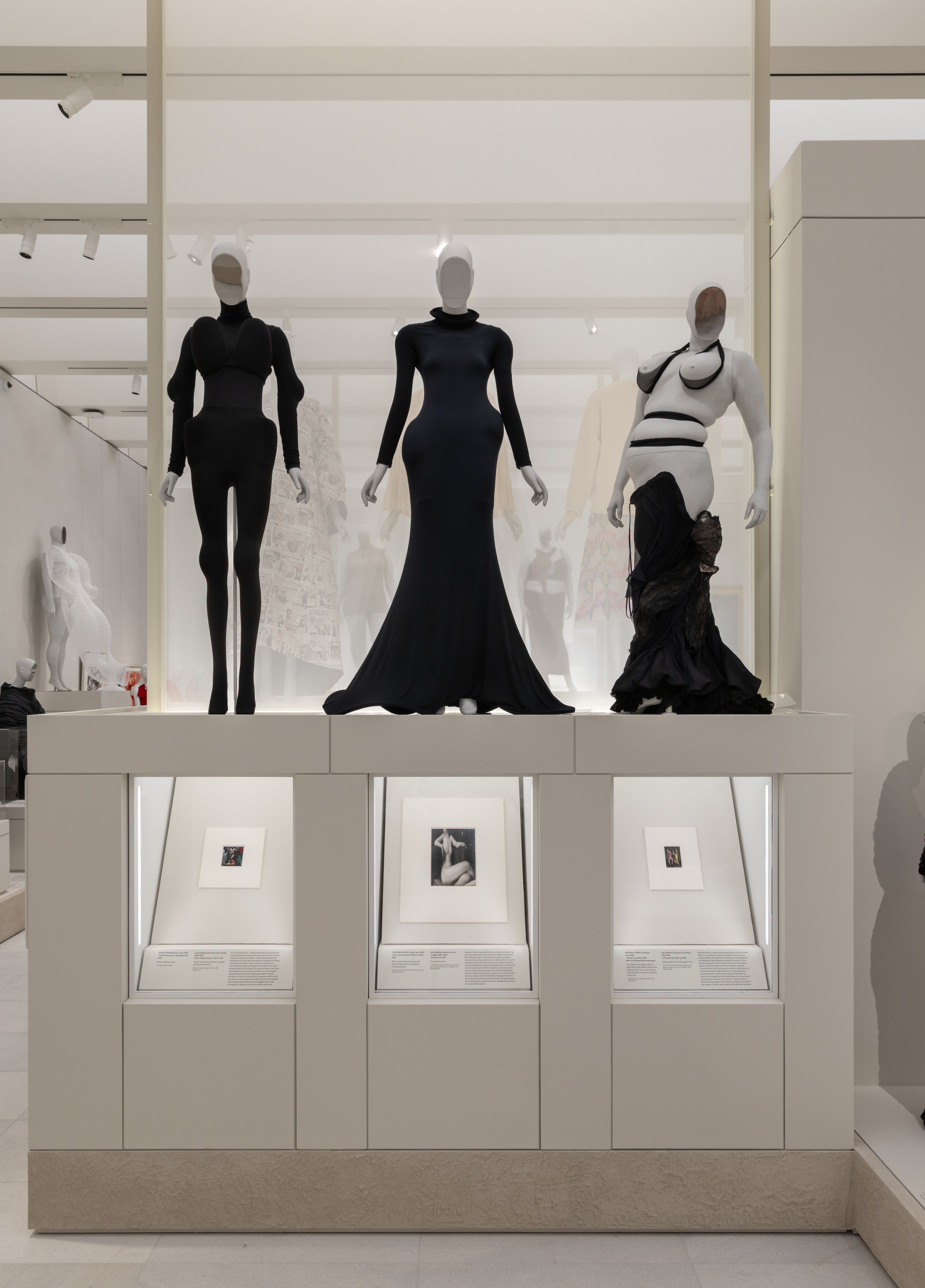 three mannequins of diverse body shapes in black dresses