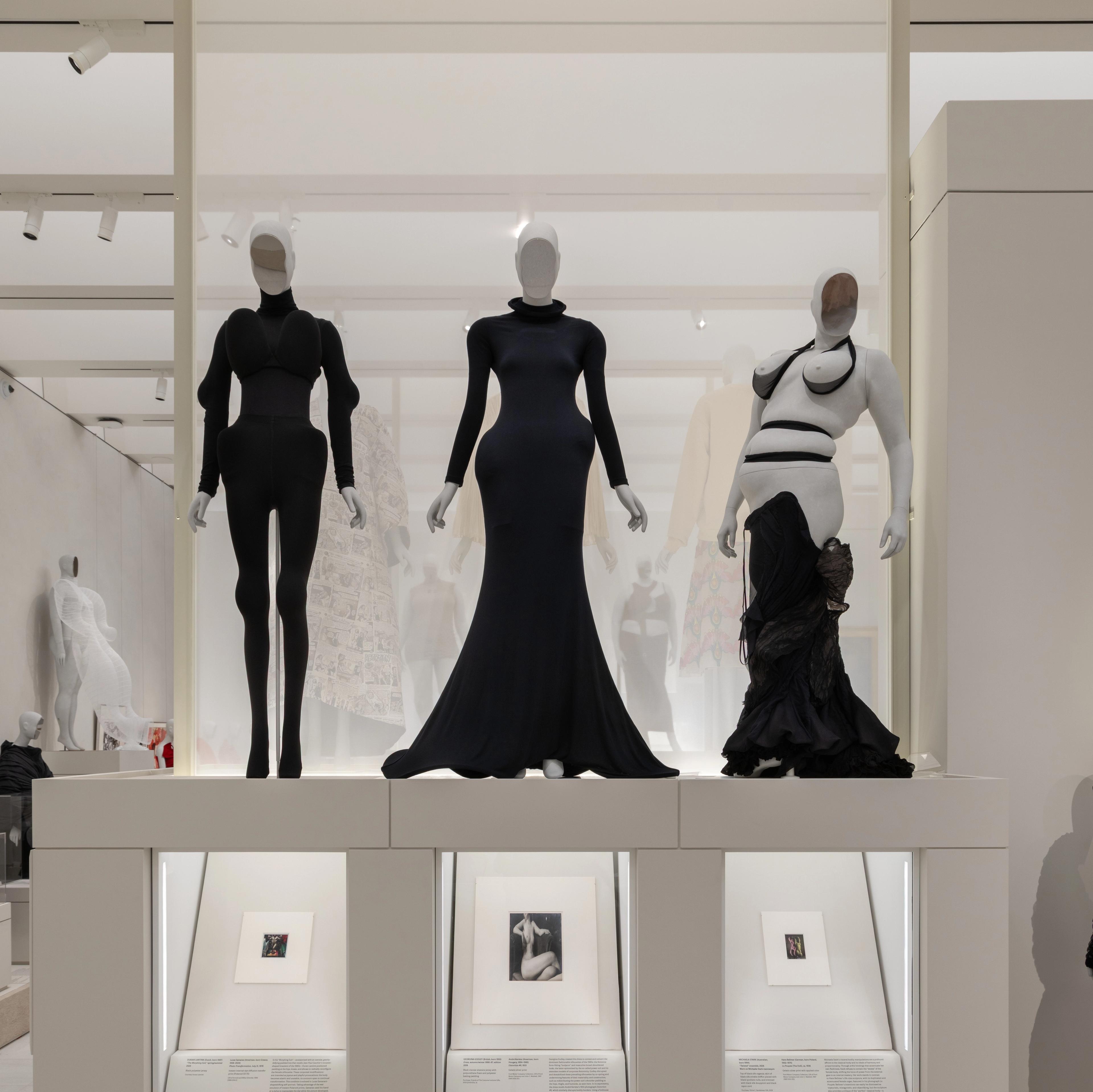 three mannequins of diverse body shapes in black dresses