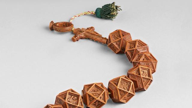 String of intricately carved, wooden rosary beads