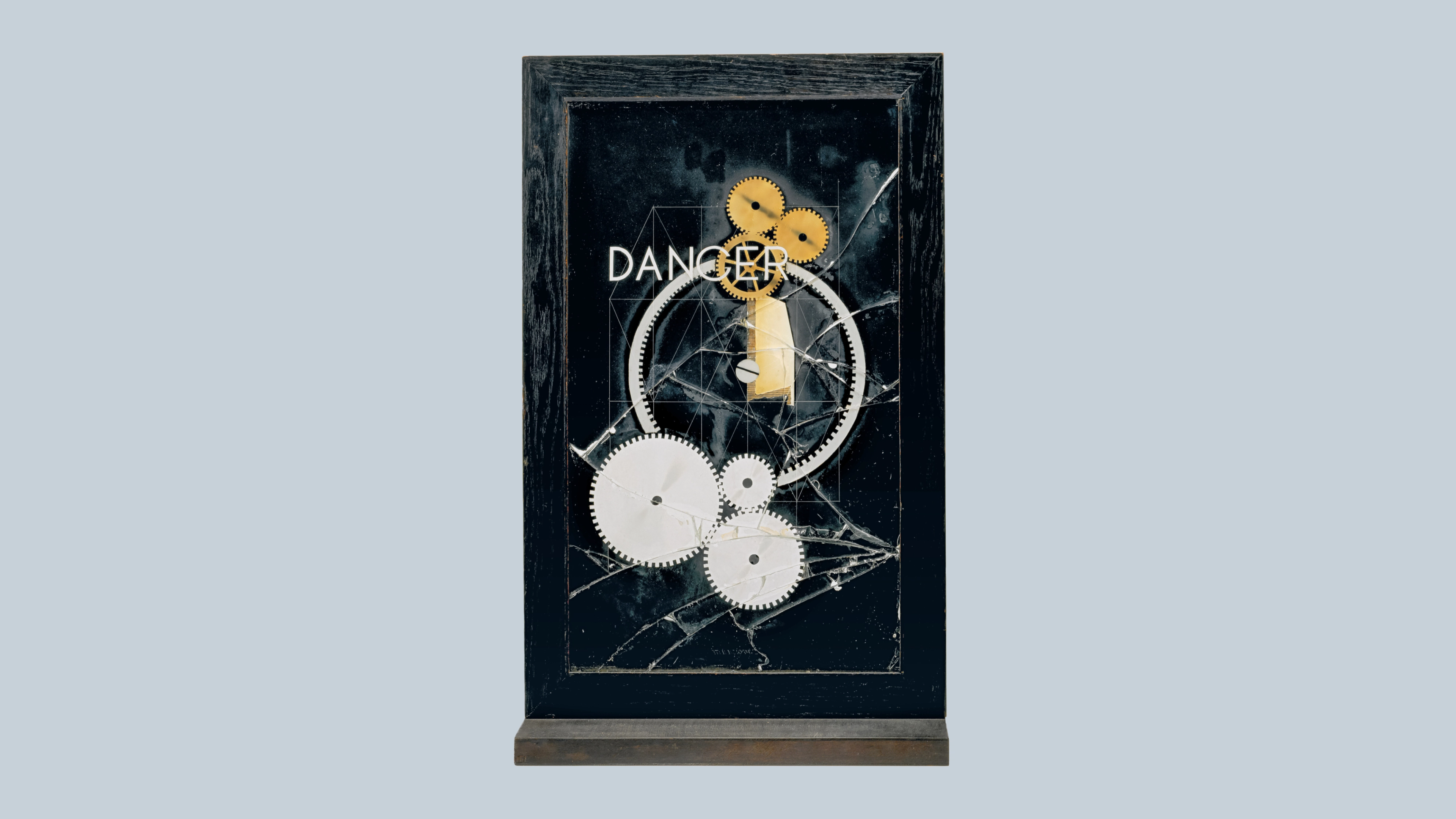 Three interlocking golden round gears, a clock-like mechanism, shattered glass, geometric lines, and with a printed work that can be read as "DANCER” or "DANGER" with a black background.