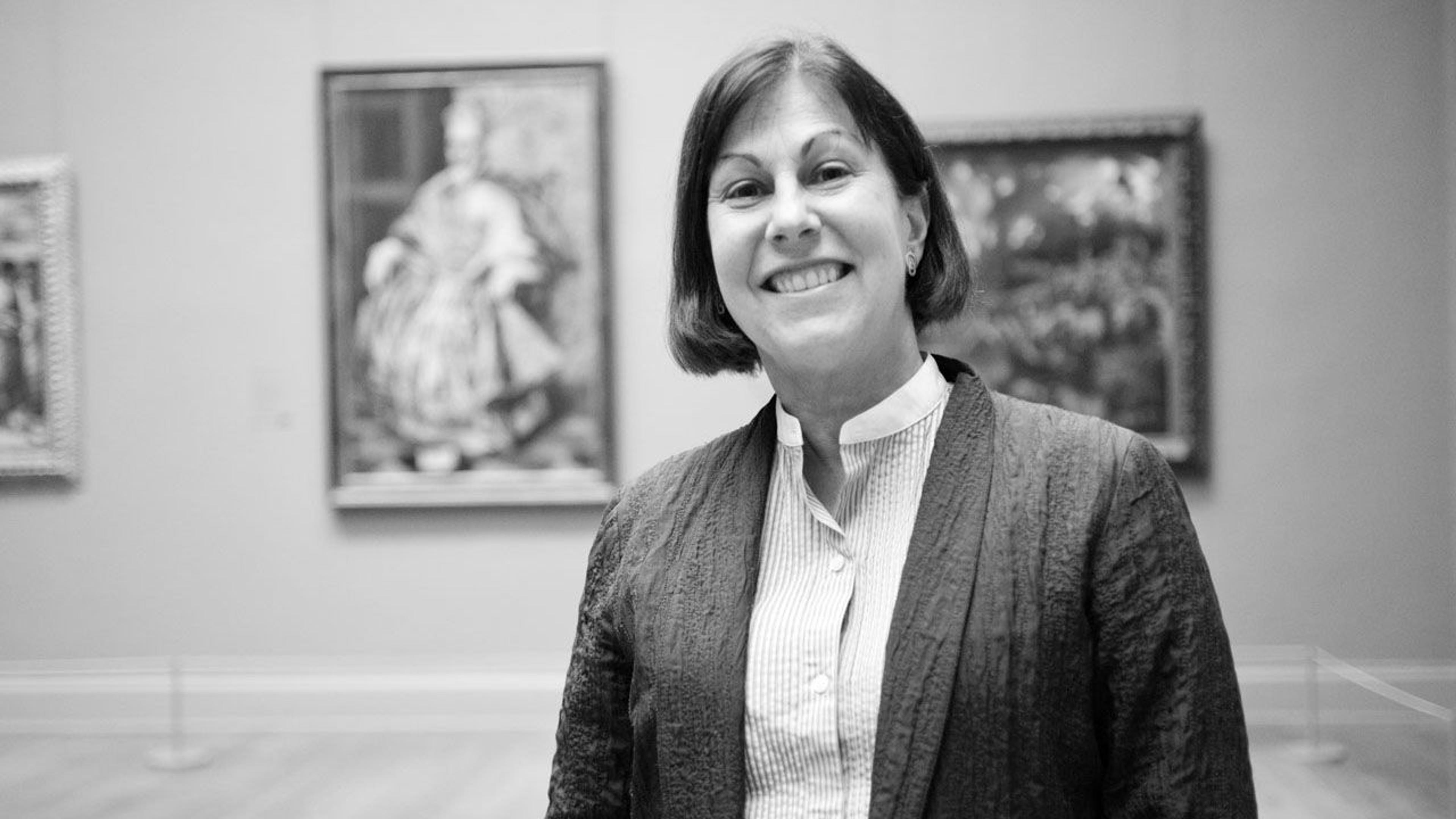 Black and white photograph of educator Inés Powell standing in a gallery at The Met