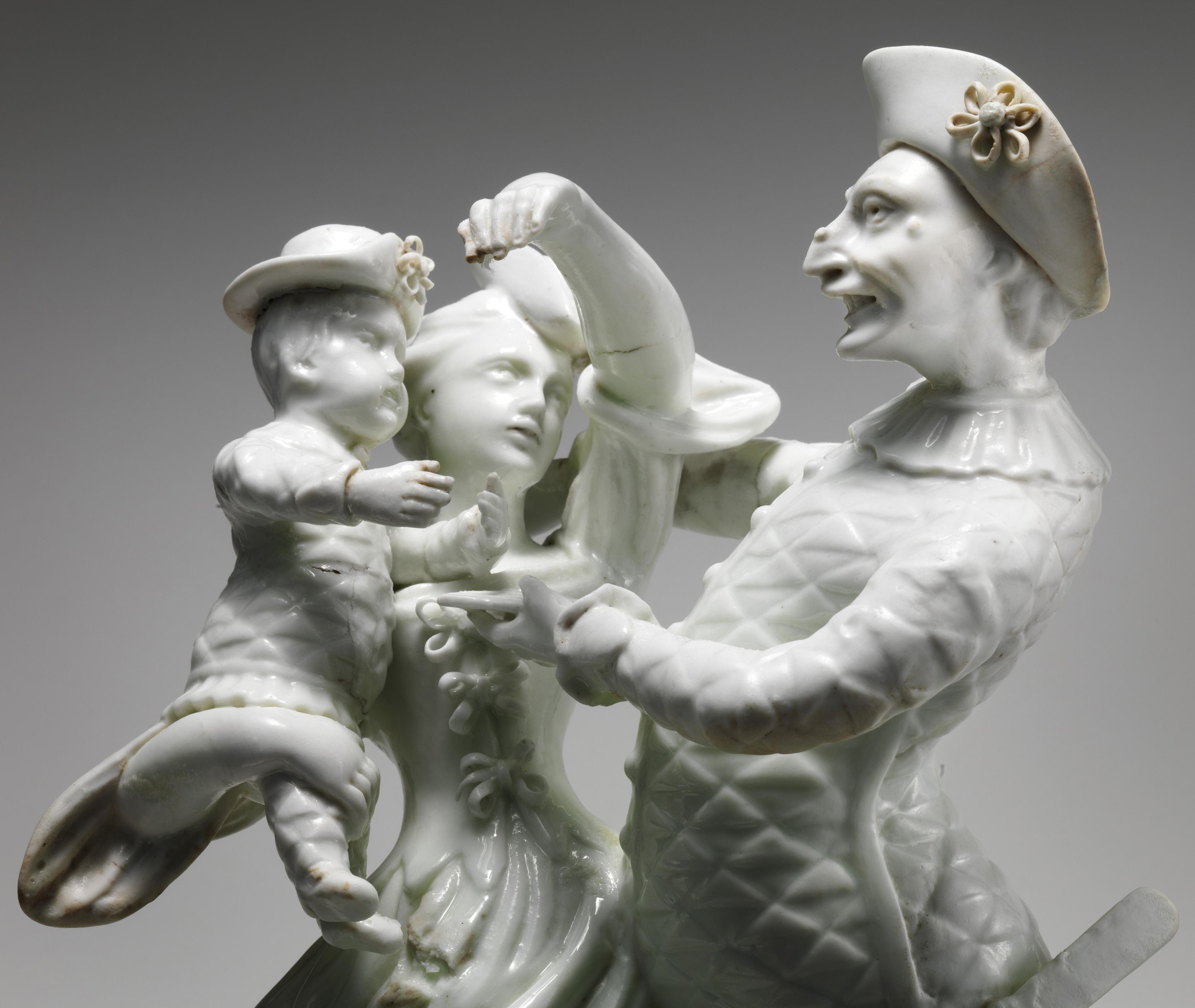Figurine in white porcelain of a man, a woman, and a child.