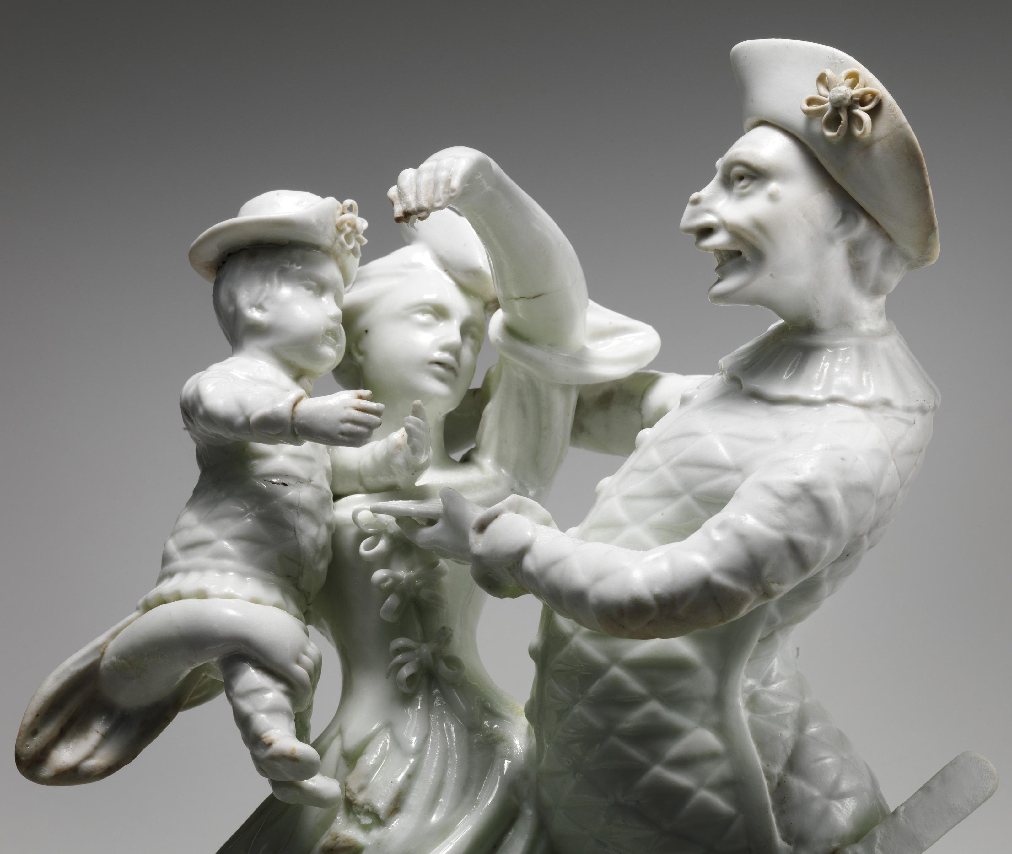 Figurine in white porcelain of a man, a woman, and a child.