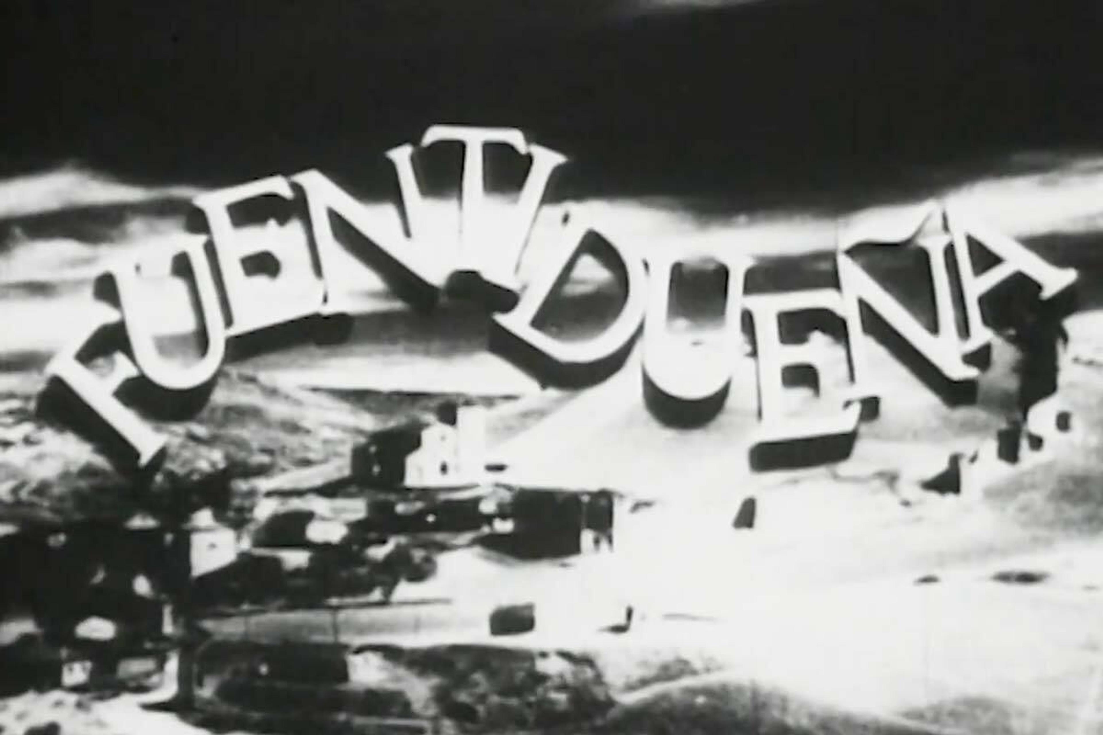 The word "FUENTIDUEÑA" prominently displayed in stylized text, against a backdrop of a black and white landscape.