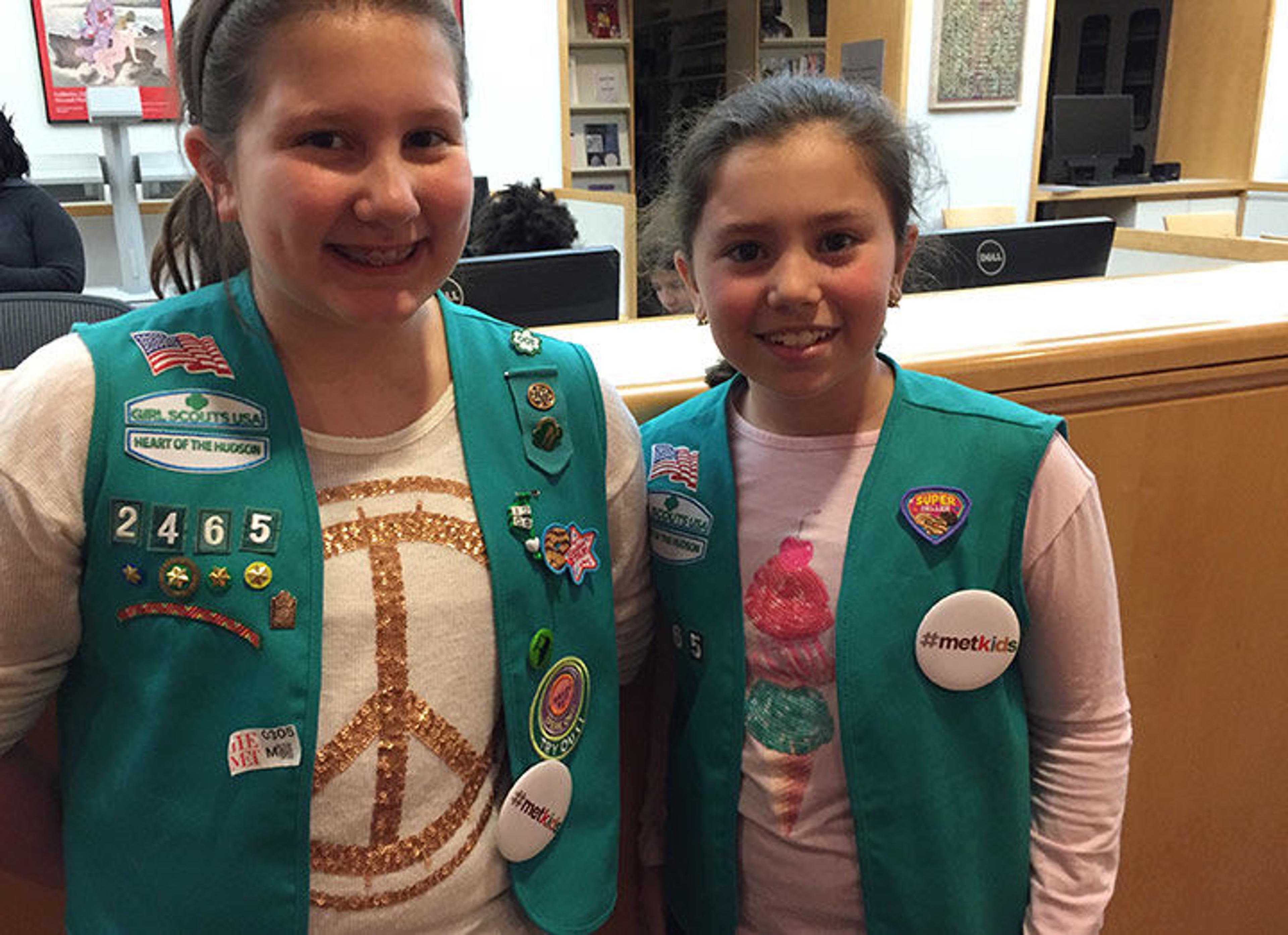 Two girl scouts wearing their #MetKids pins