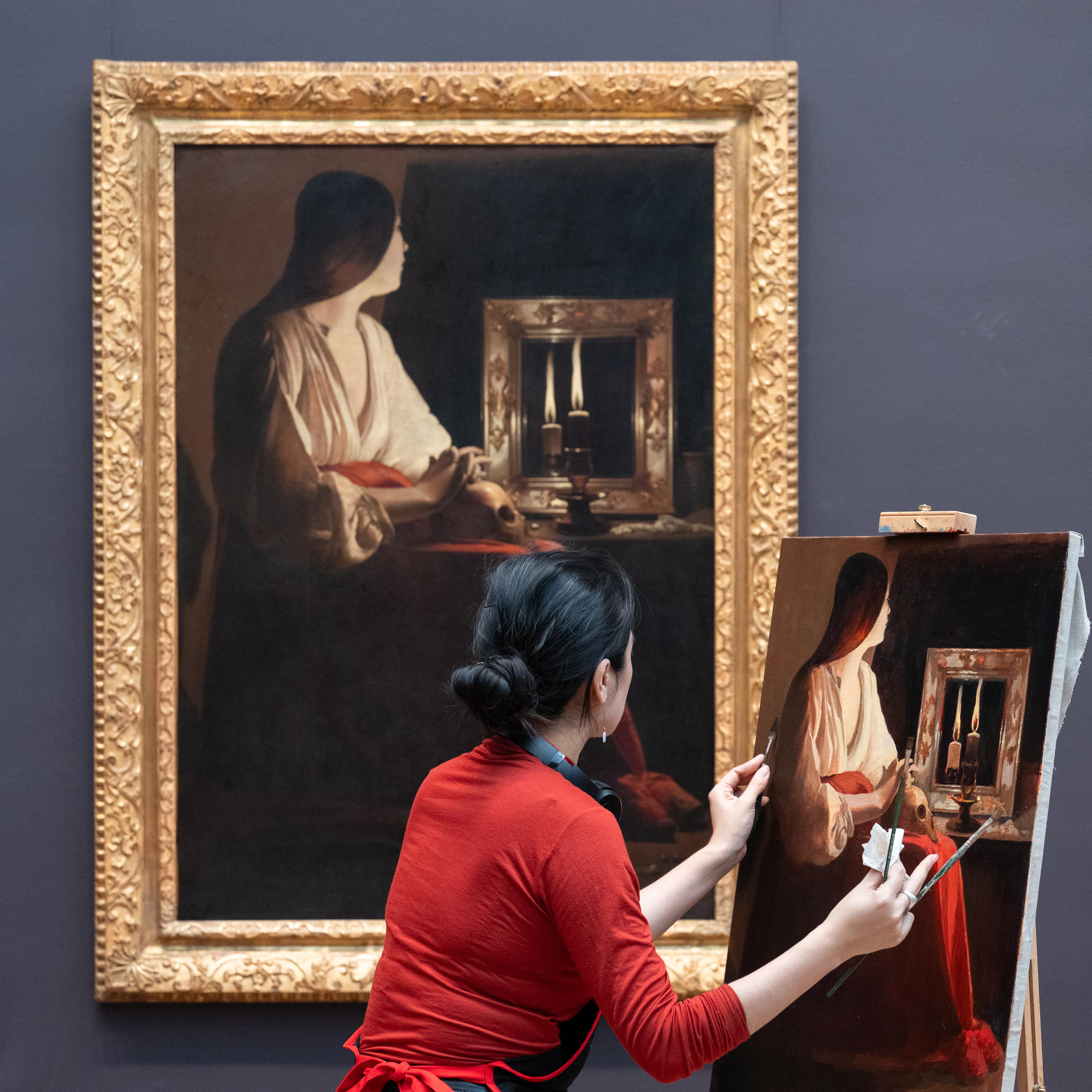 A woman painting on a canvas