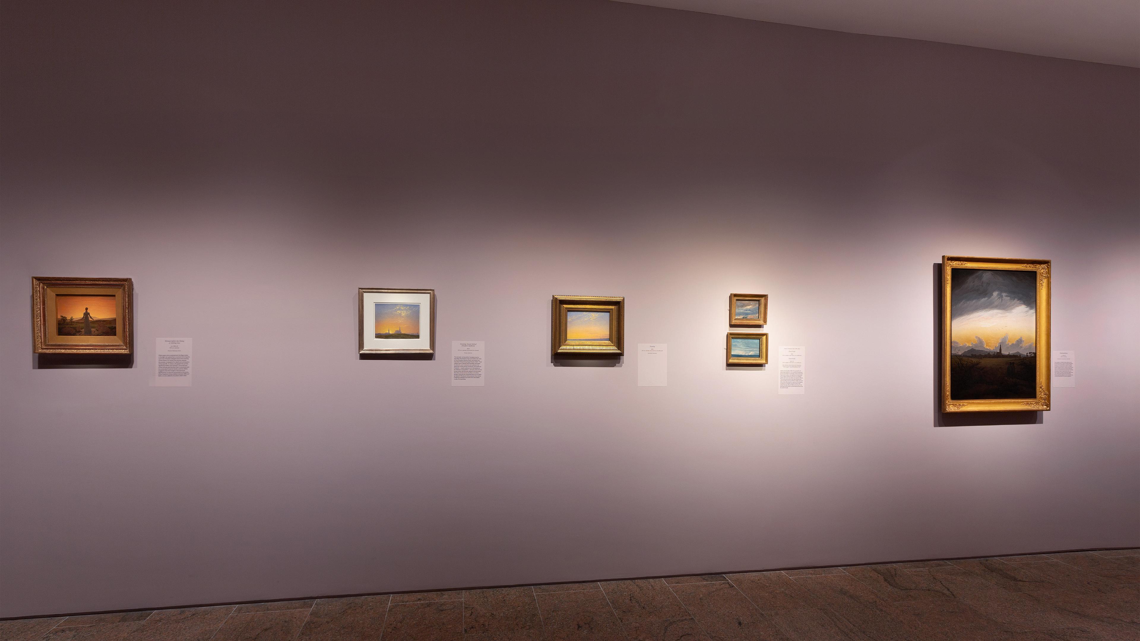Wall gallery view with paintings hanging on the walls.