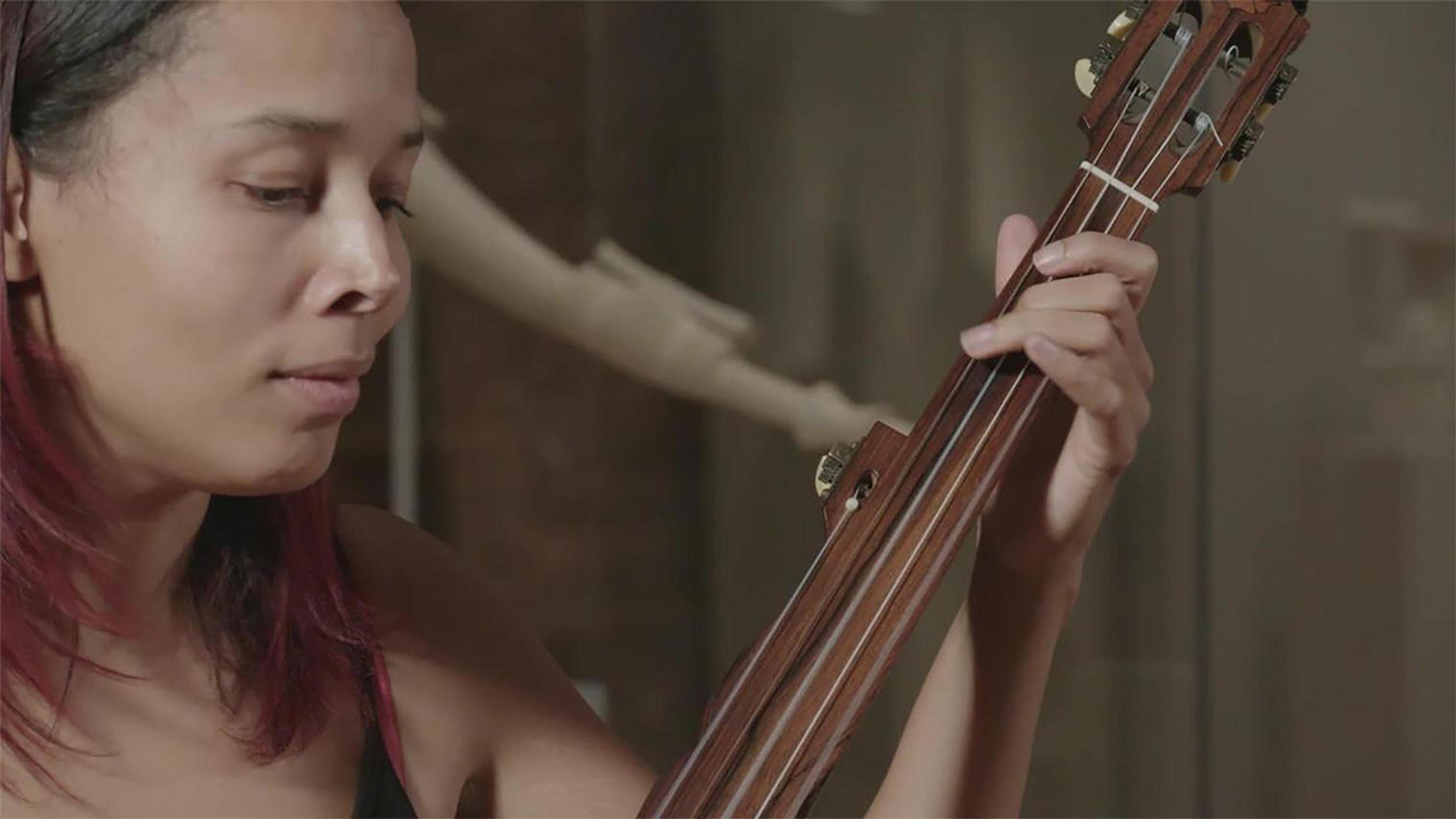 A woman plays a stringed instrument