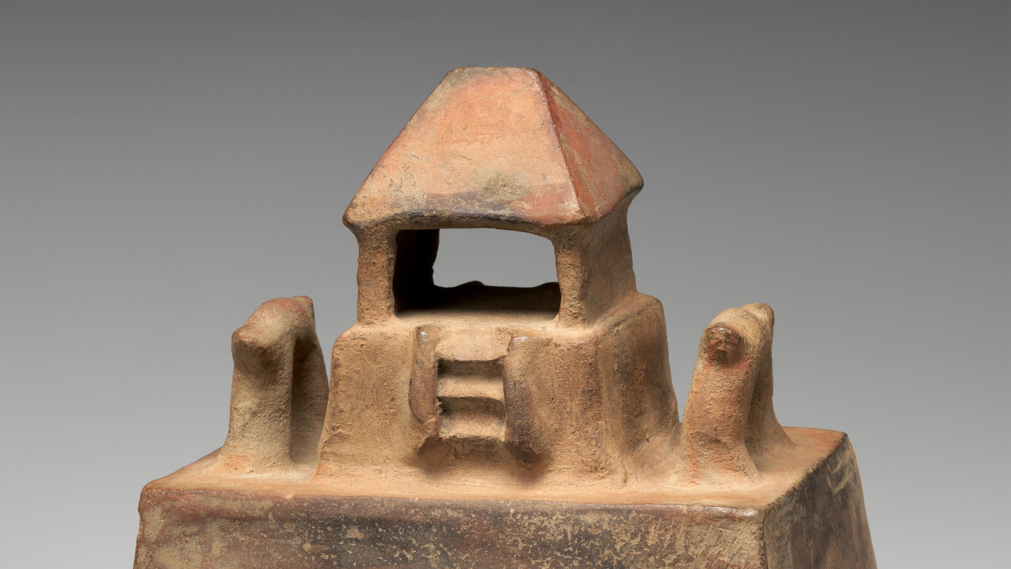 Ceramic temple model with a small platform surmounted by a temple with a peaked roof