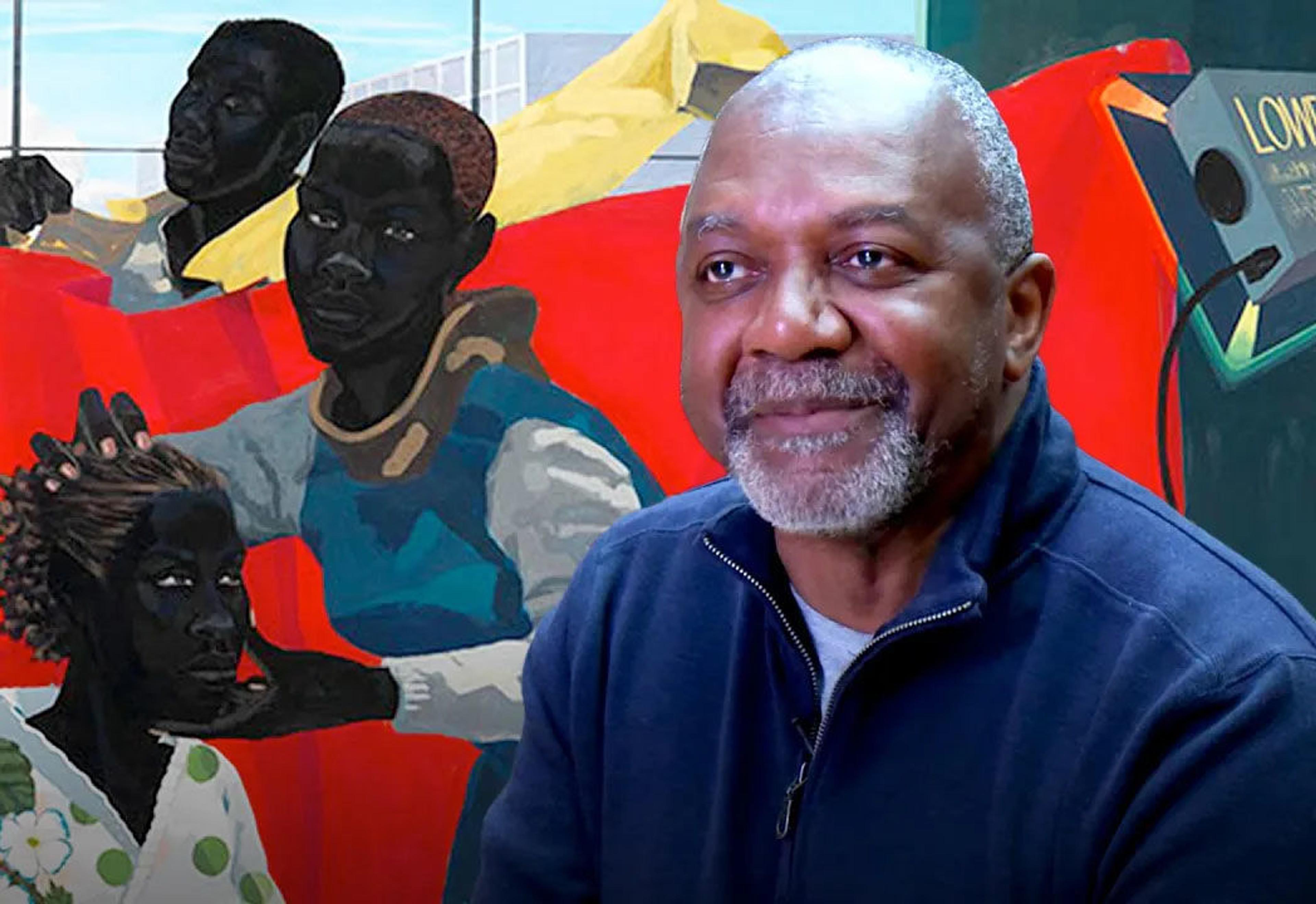 Artist Kerry James Marshall sits in front of one of his paintings