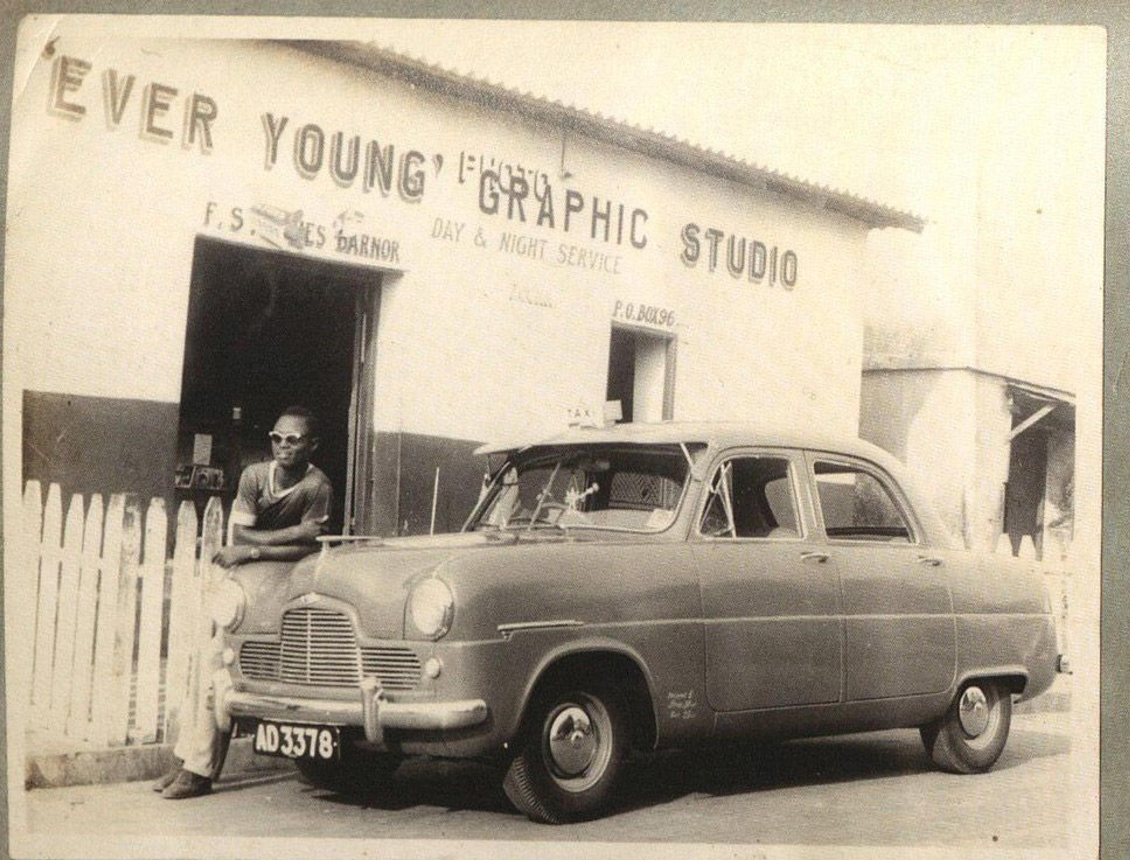 Man leaning against a car