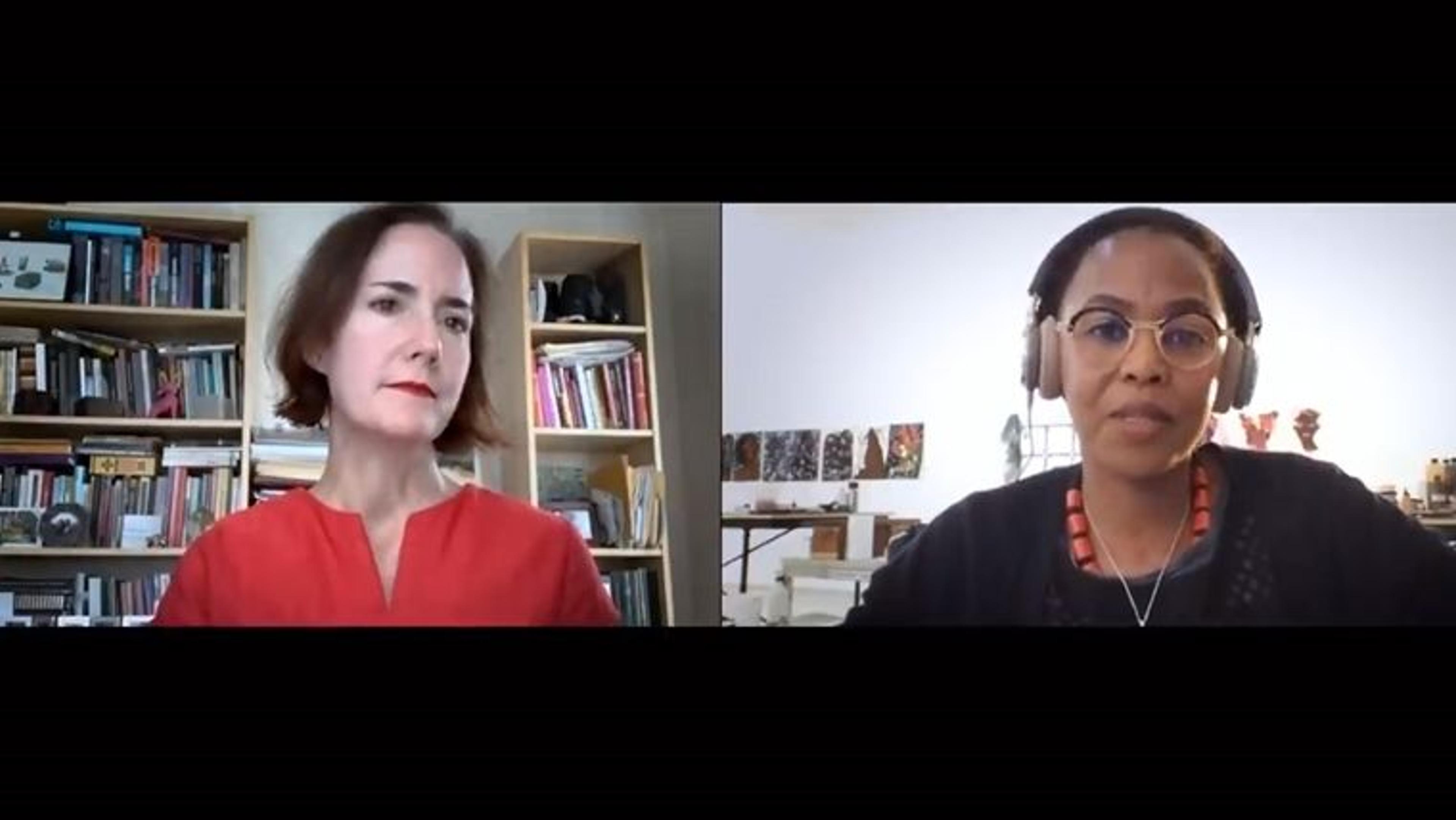 A screen capture of two women in their separate offices, facing forward, via a teleworking program.