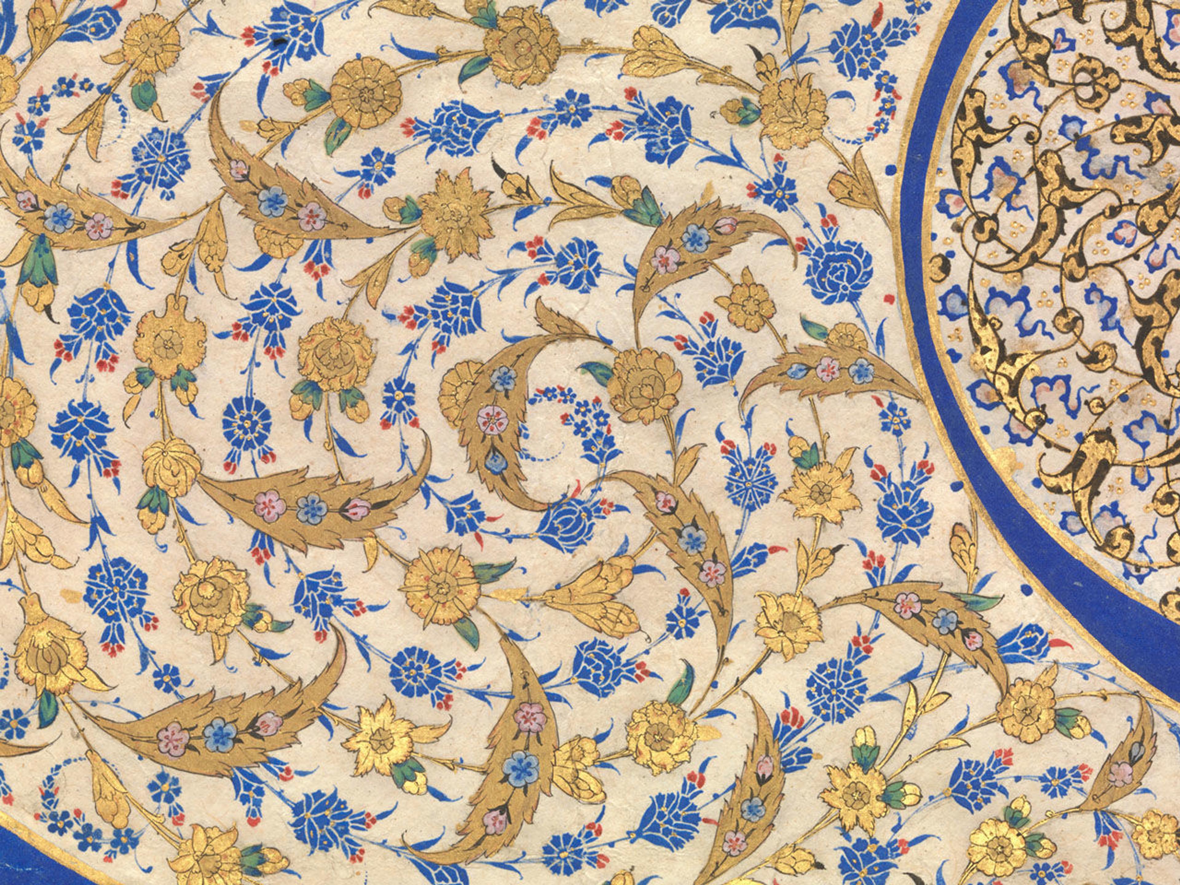 Close up view of the pattern of blue and gold flowers that make up the center swirl in a Turkish tughra.