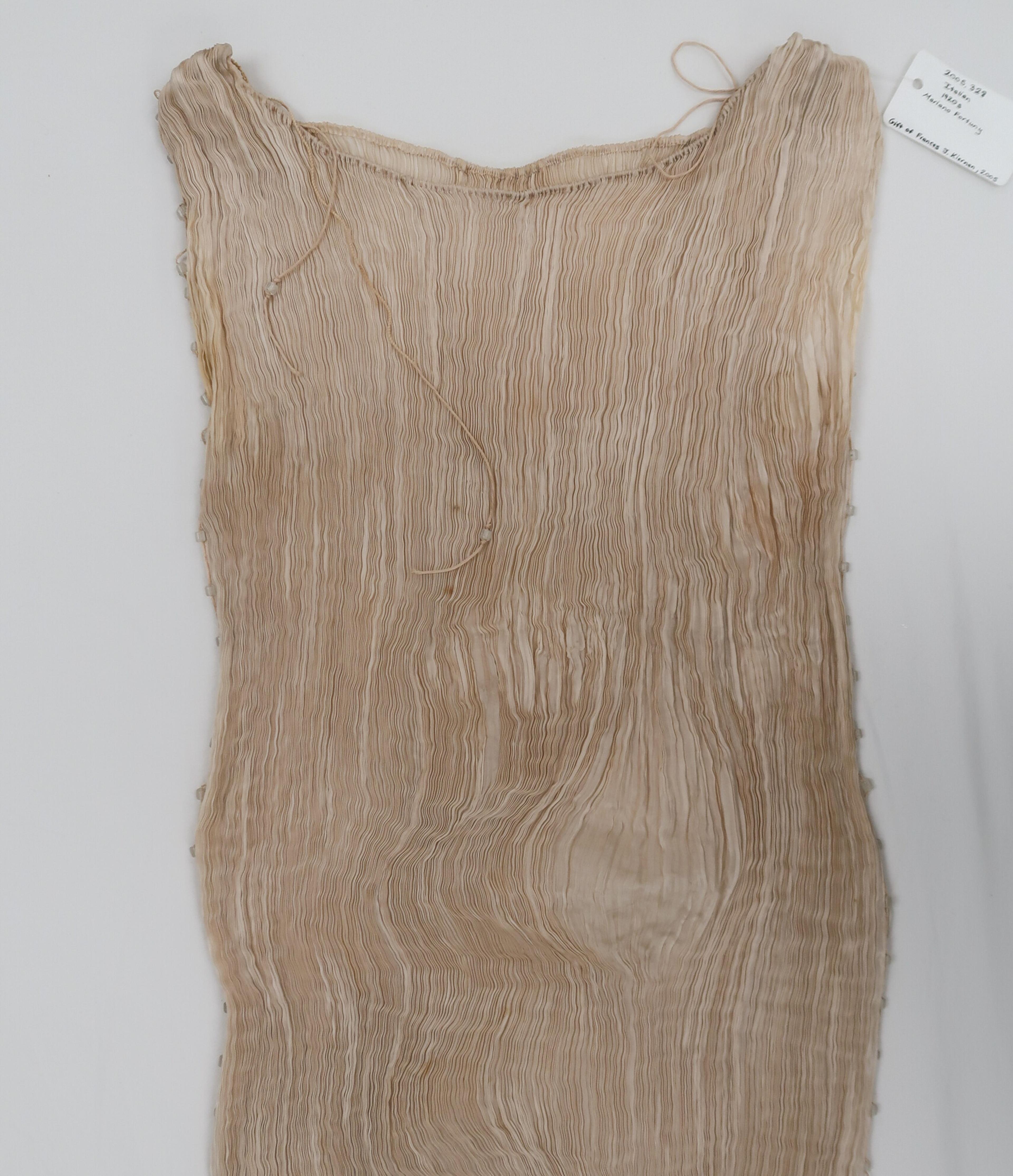 The top part of the Delphos gown, with a large unpleated area at the left hip.