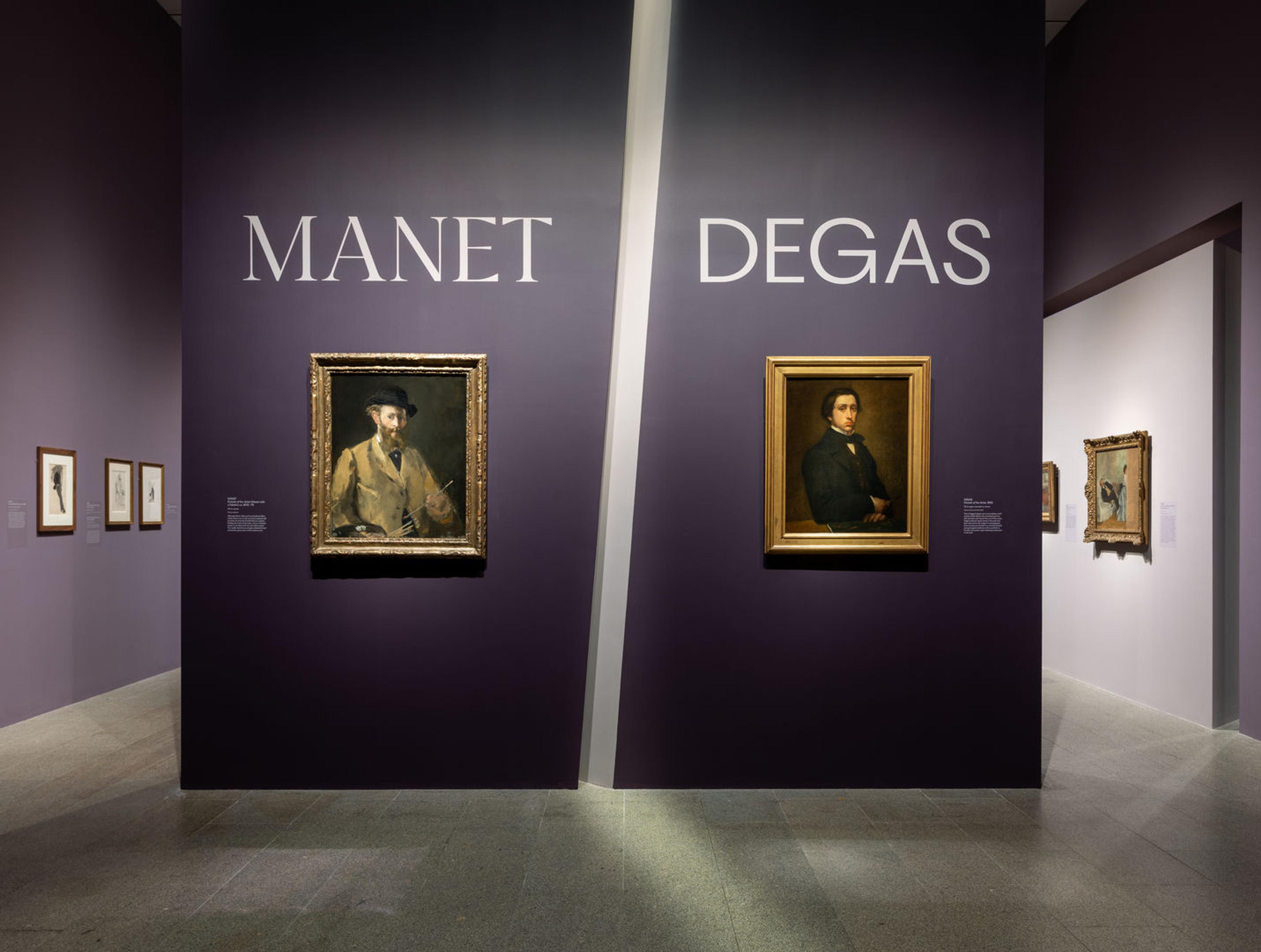 Man and woman standing in purple gallery as they look at painting