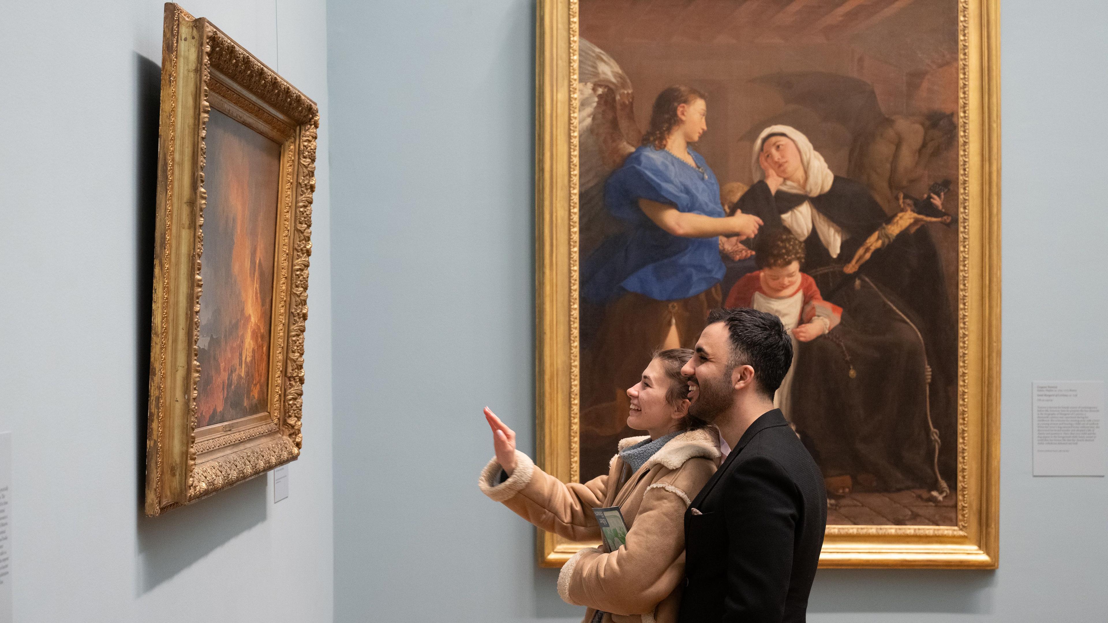 Two Museum visitors admire a work of art in The Met's European Paintings galleries.