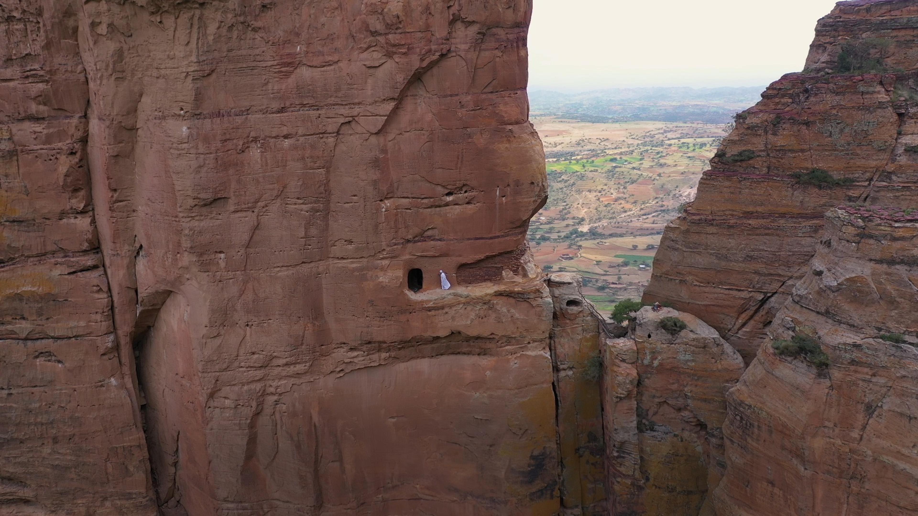 (Priest) walking on the ridge of the hill in Tigray