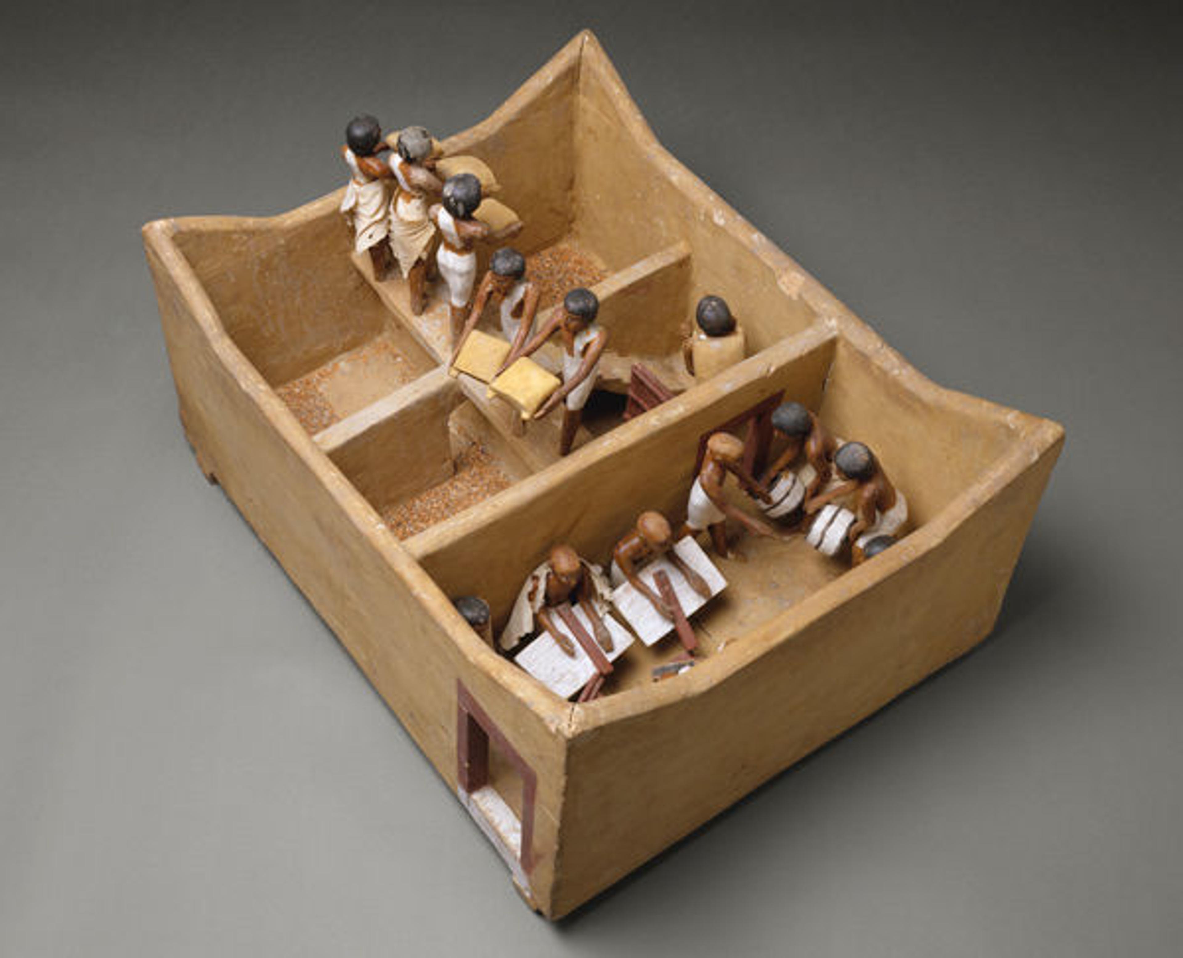 Model of a Granary with Scribes. Middle Kingdom, Dynasty 12, early reign of Amenemhat I (ca. 1981–1975 B.C.). Wood, plaster, paint, linen, grain; L. 74.9 (29 1/2 in.), W. 56 cm (22 1/16 in.), H. 36.5 (14 3/8 in.), average height of figures: 20 cm (7 7/8 in.). The Metropolitan Museum of Art, New York, Rogers Fund and Edward S. Harkness Gift, 1920 (20.3.11)